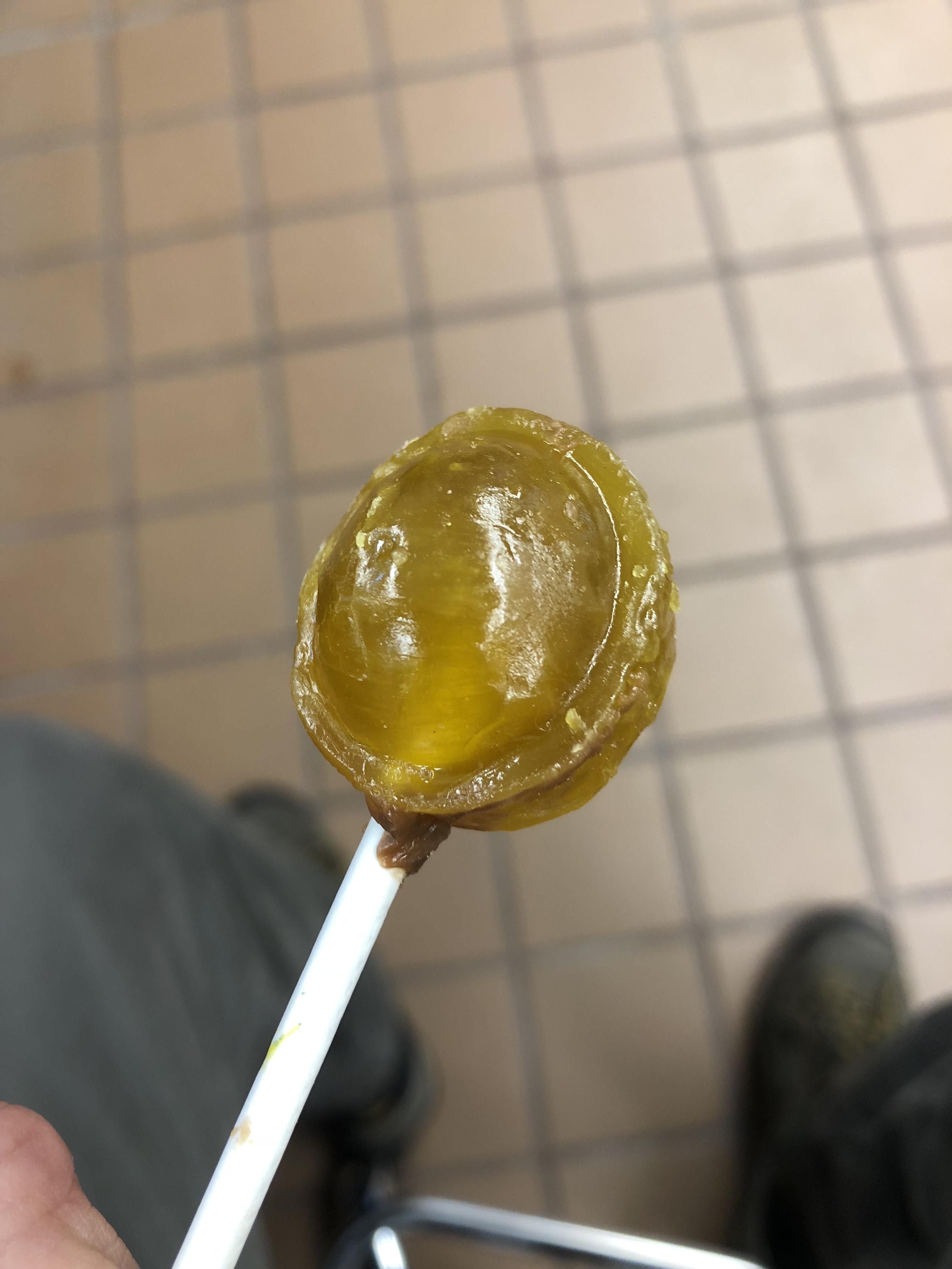 Lemon Tootsie Pops kind of look like candied urine with poop in the
