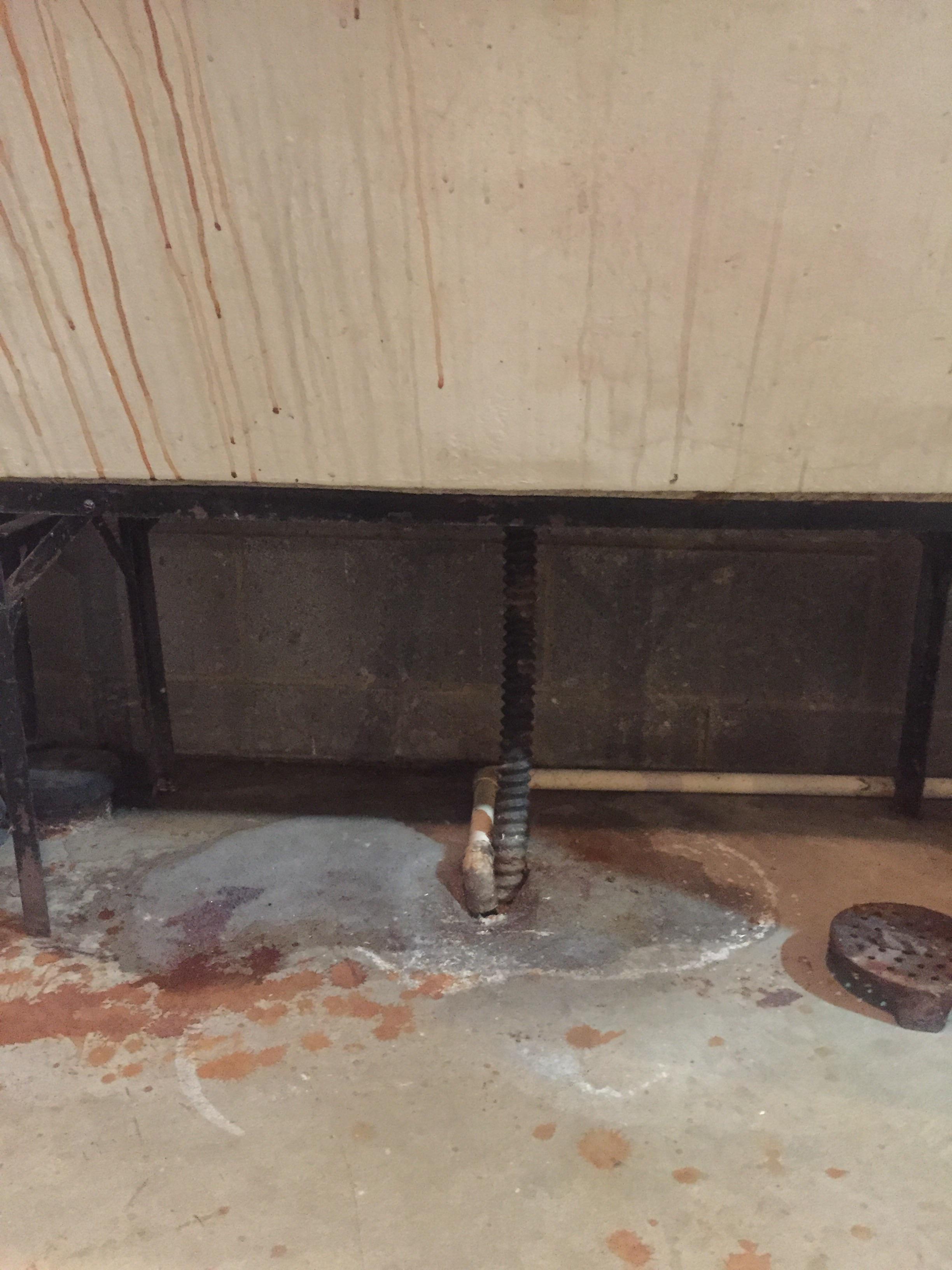 Basement washtub drains into hole (floor drain?) in the concrete