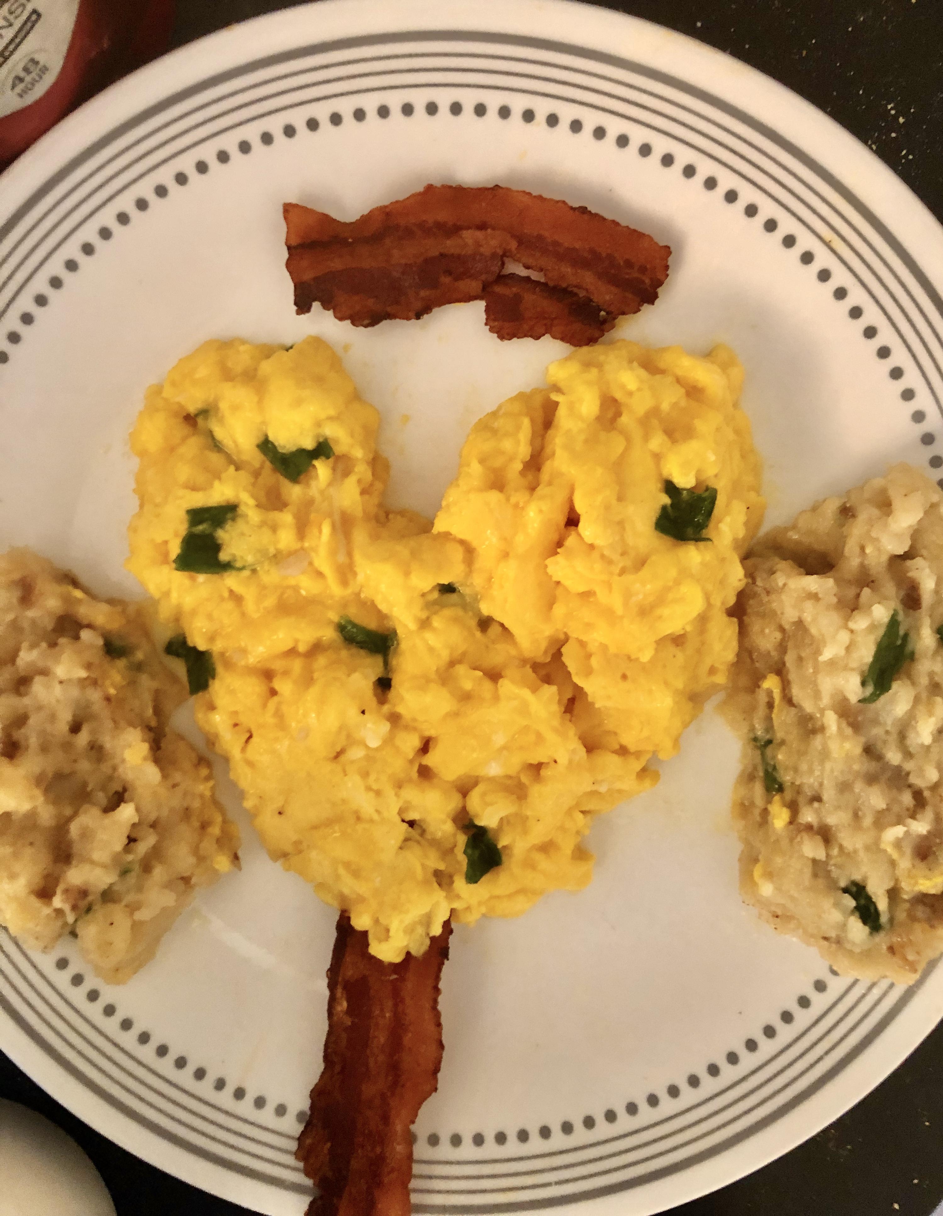 Soft hearty scrambled ramp eggs with pomme purée and ovenbaked bacon