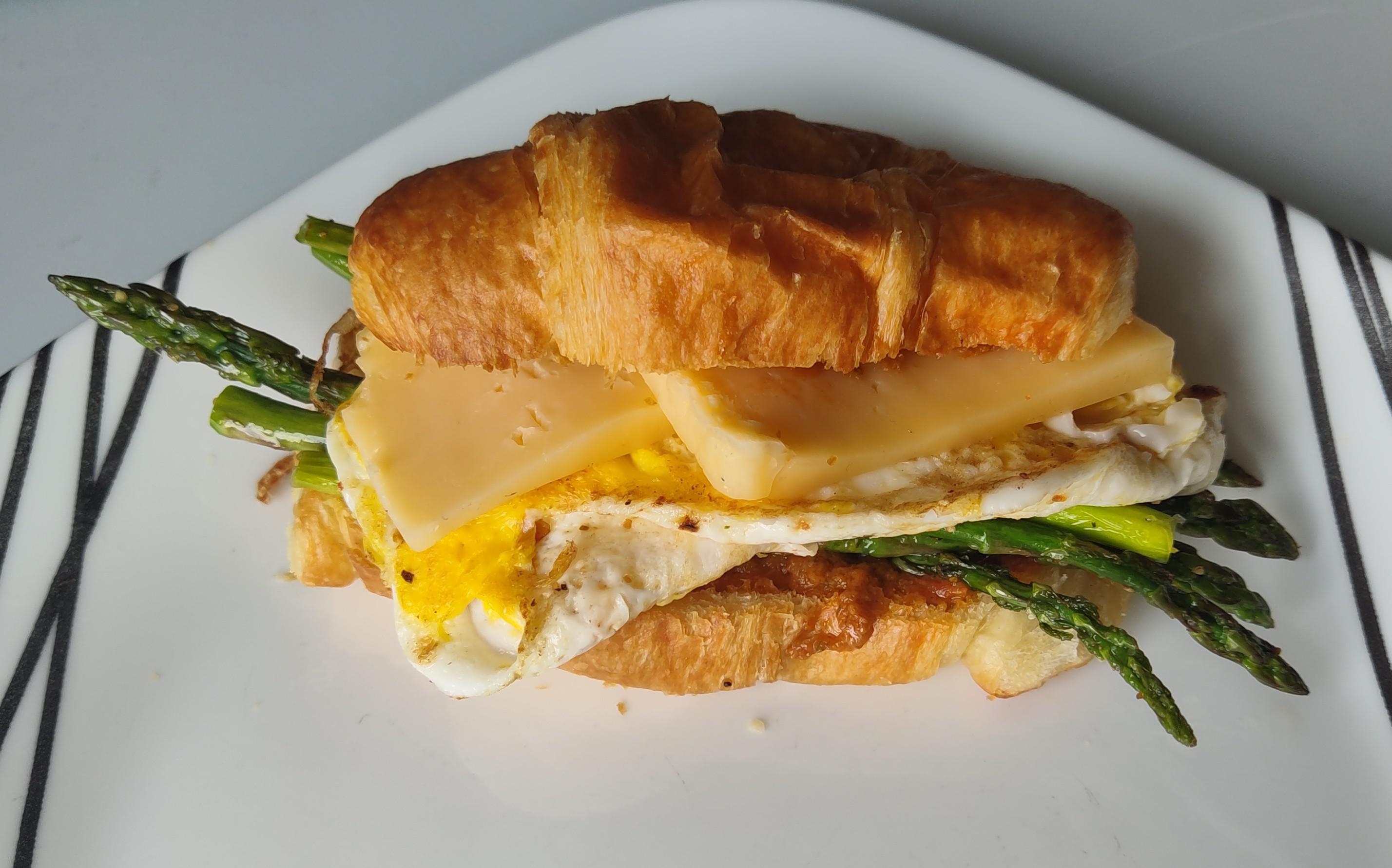 Asparagus, egg, havarti, and sun dried tomato pesto on a mini croissant