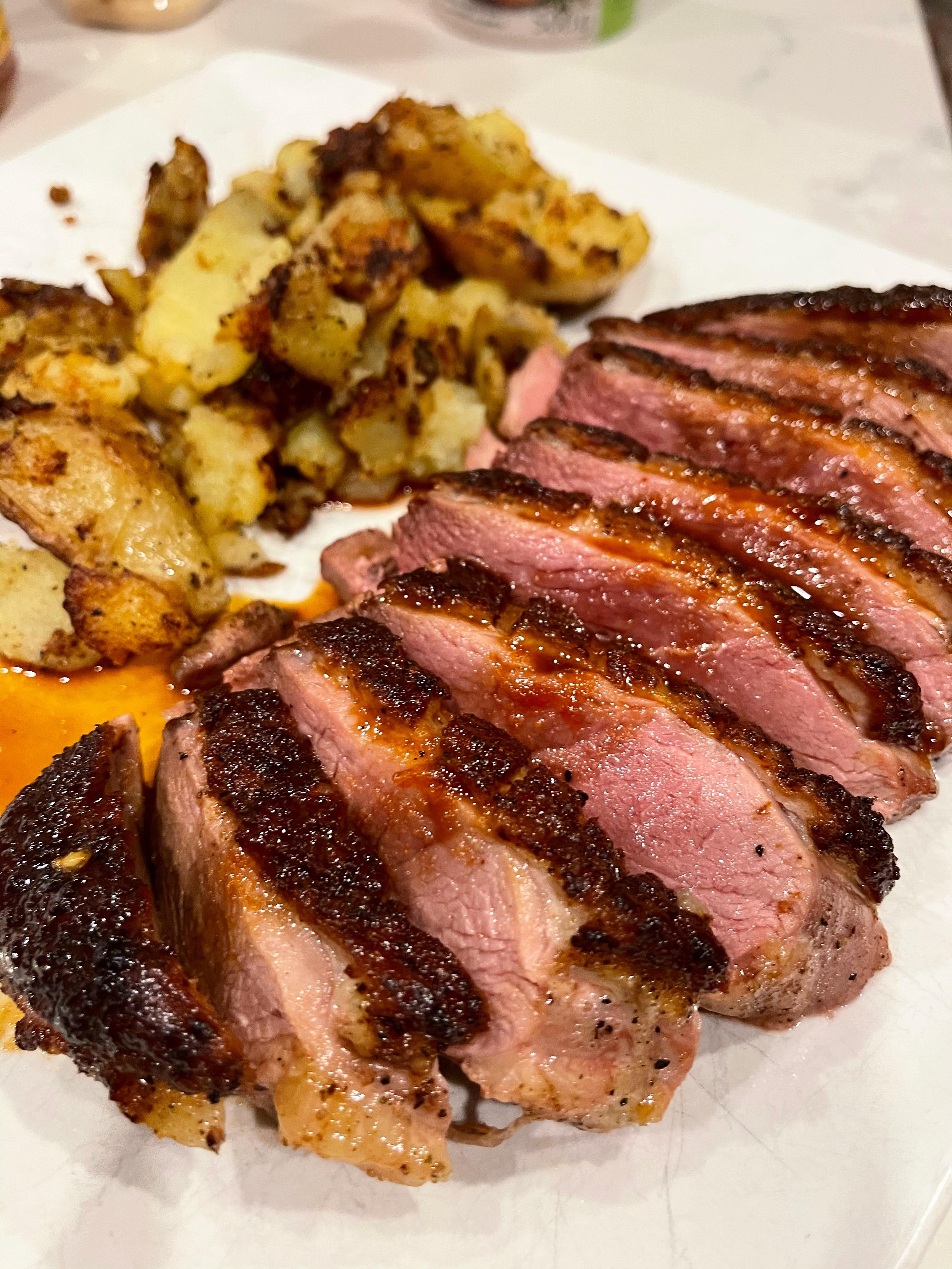 Duck steak (Magret) cooked in the cast iron with duck fat fried smashed