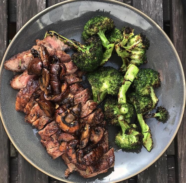 Strip steak, broccoli and sautéed mushrooms. All done over the coals