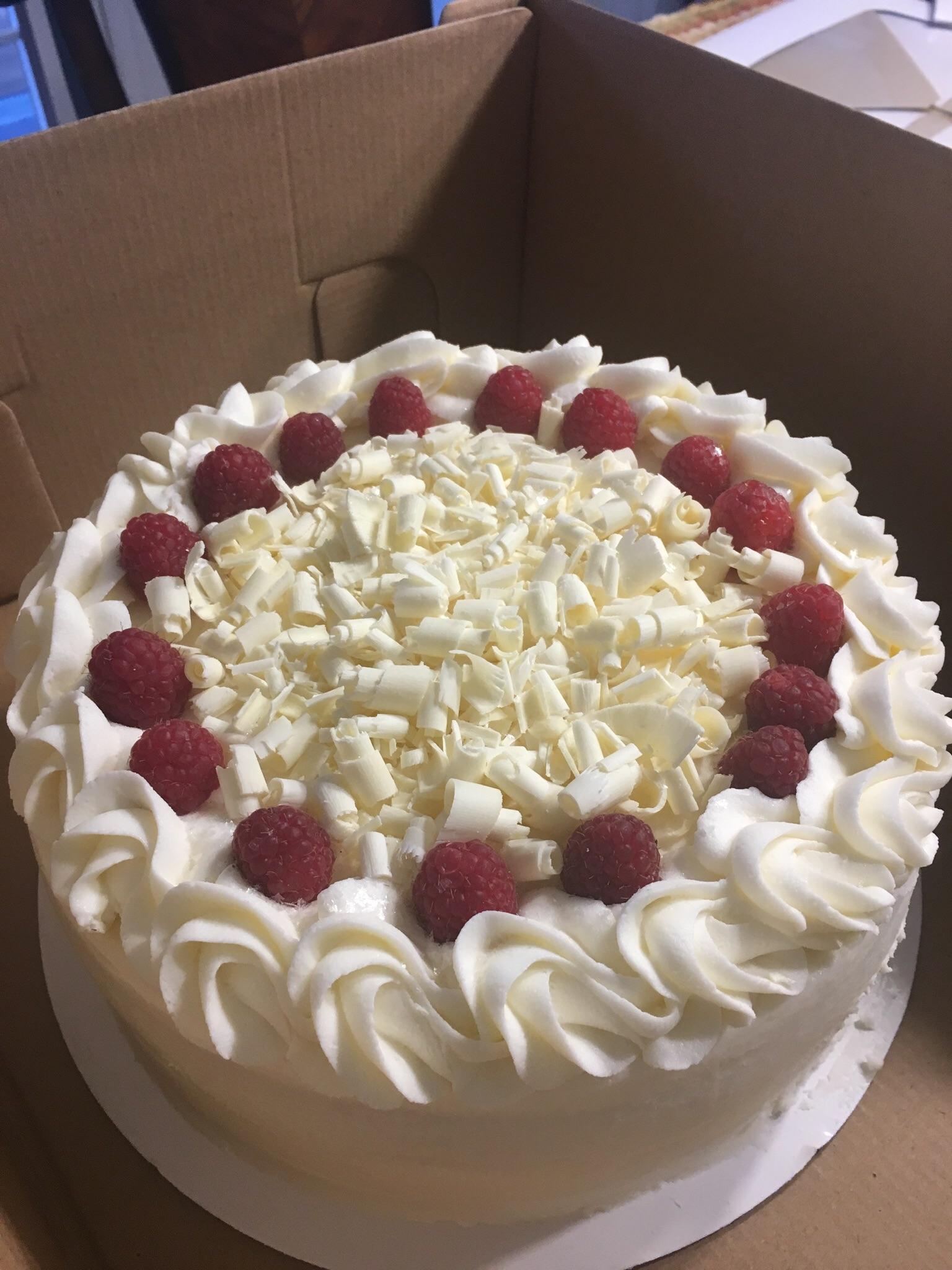 White chocolate cake filled with fresh raspberries soaked in Chambord