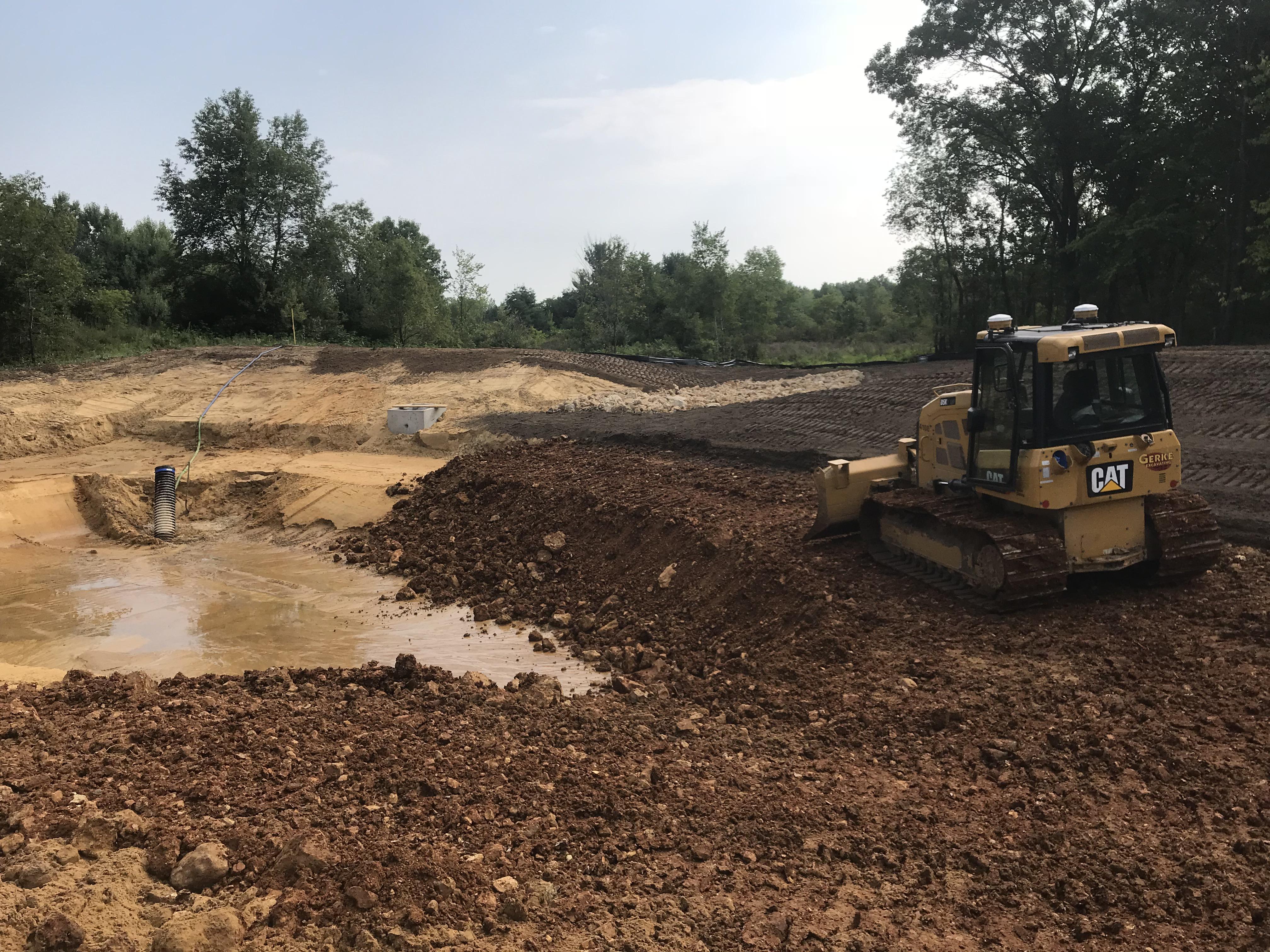 Putting a clay liner in on retention pond with a D5K r/heavyequipment