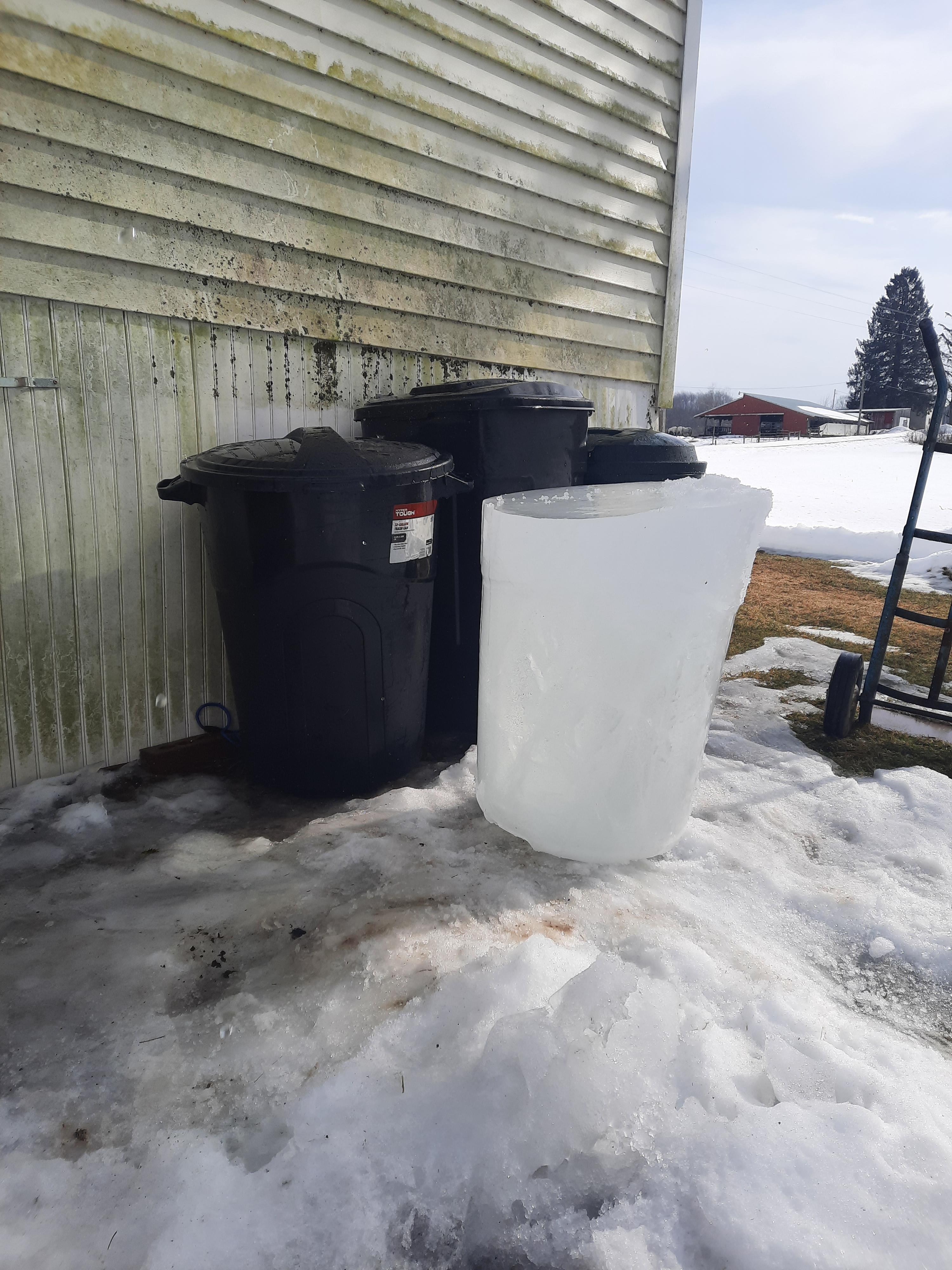 Garbage can filled up with water, then froze. Here is the huge ice