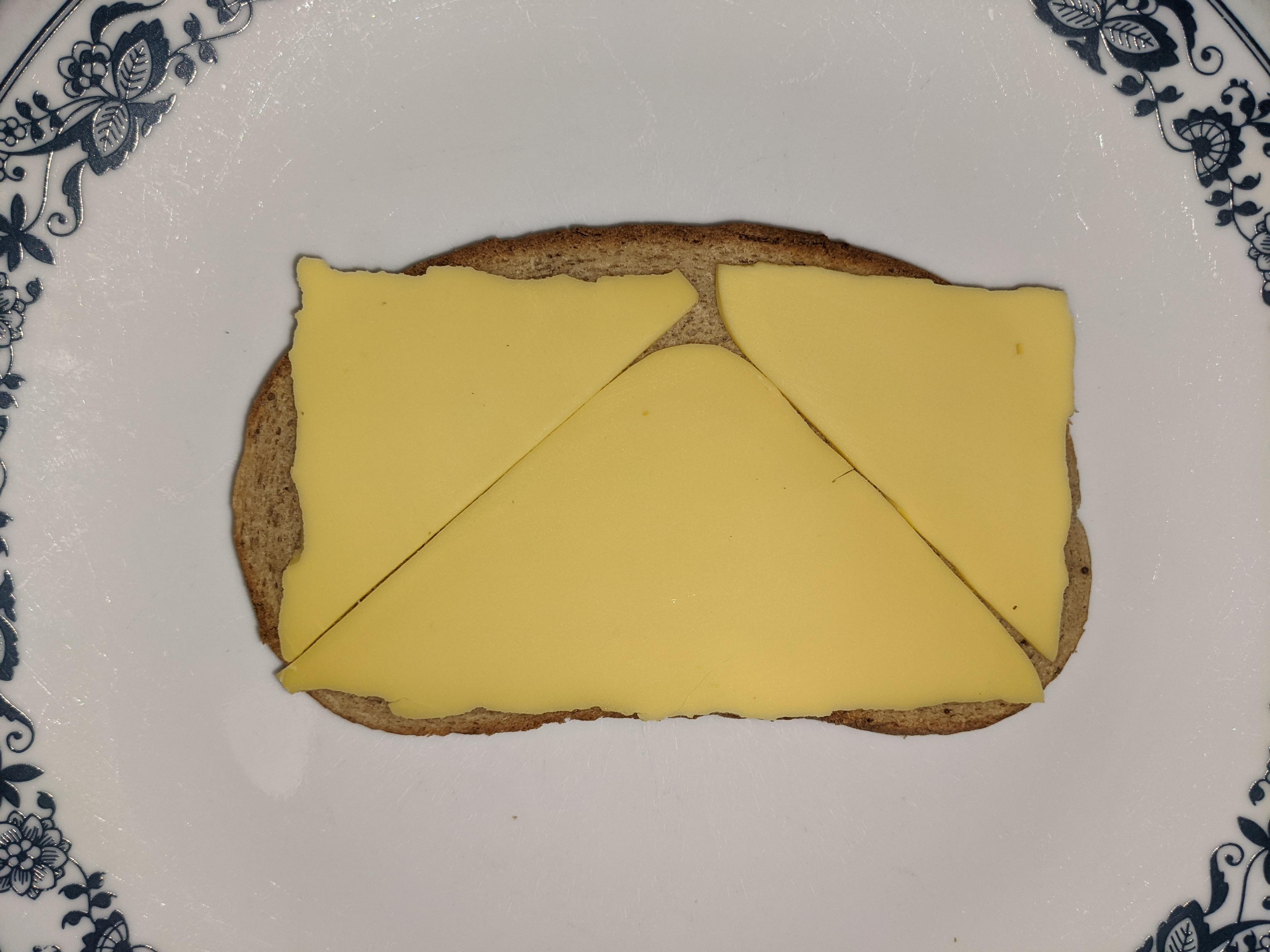 Fold square cheese into triangles to help it fit rectangular bread r