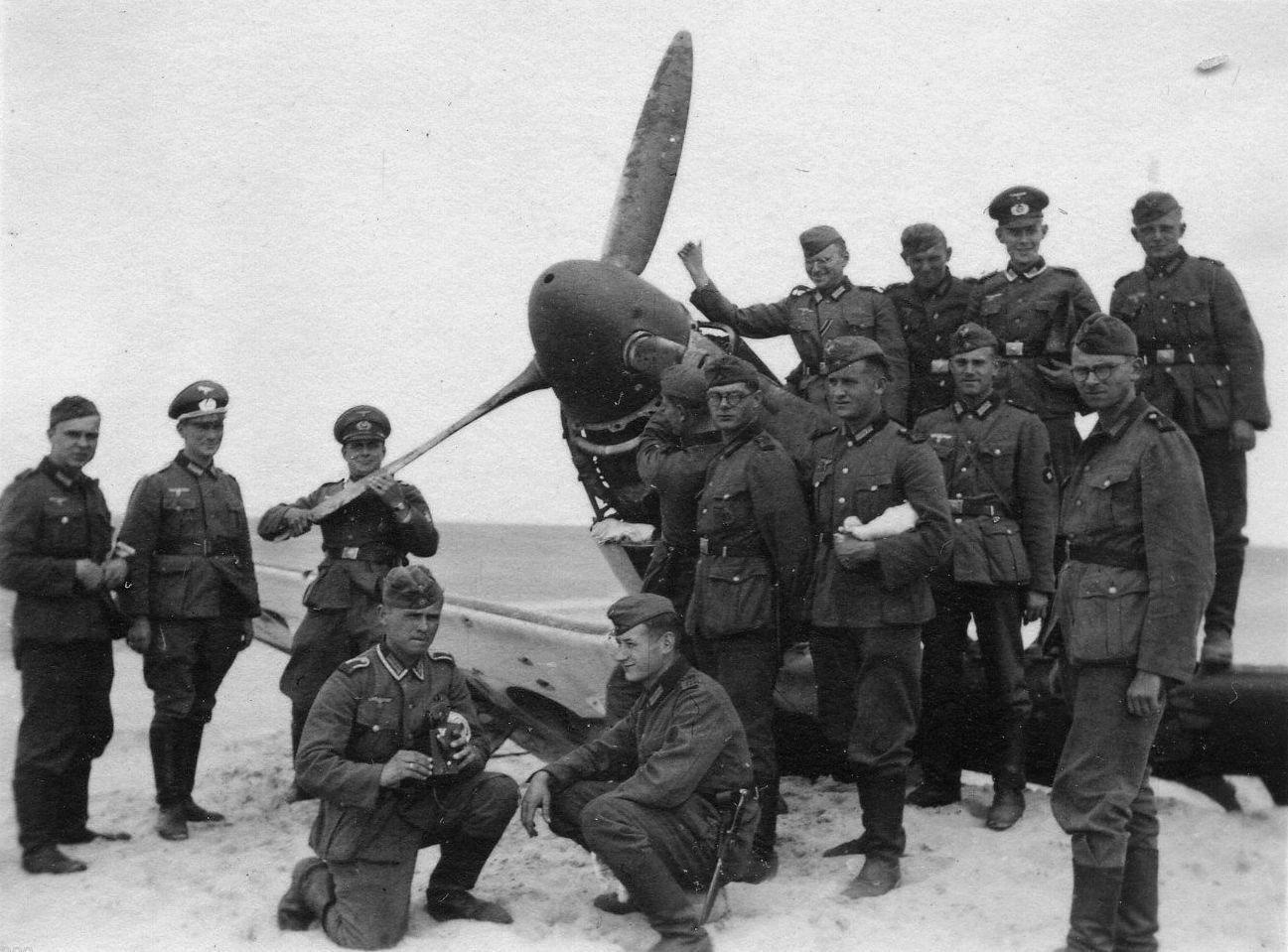 German soldiers pose with a Spitfire downed on the beach of Dunkirk