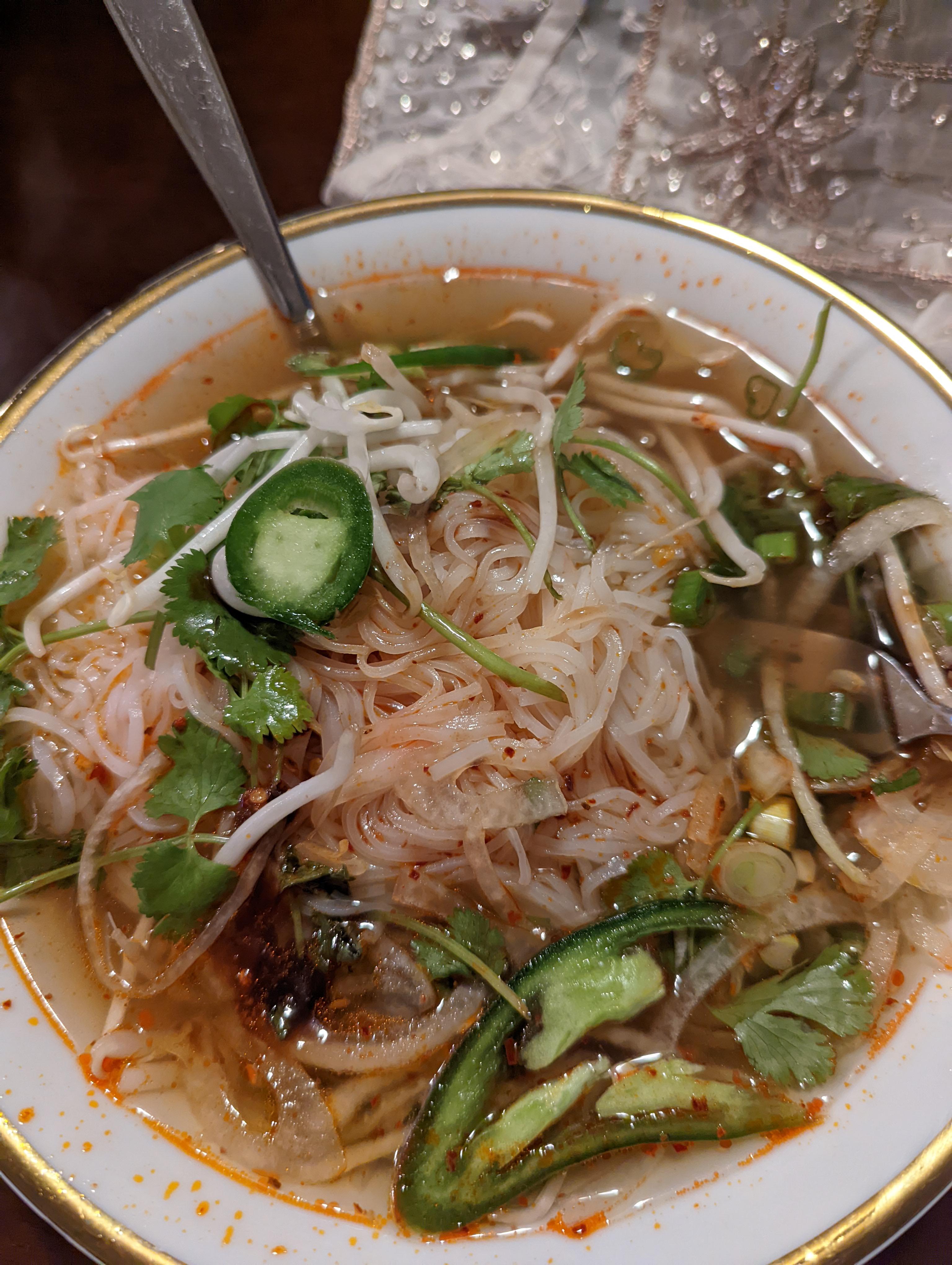 Perfect food for while sick. Beef pho with chili oil, jalapenos, lime