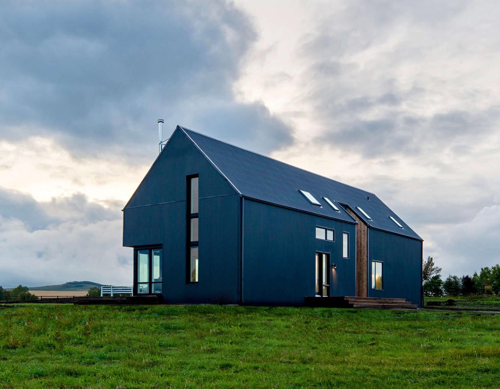 Blue modern farmhouse with 30feet ceiling and angled skylight on a