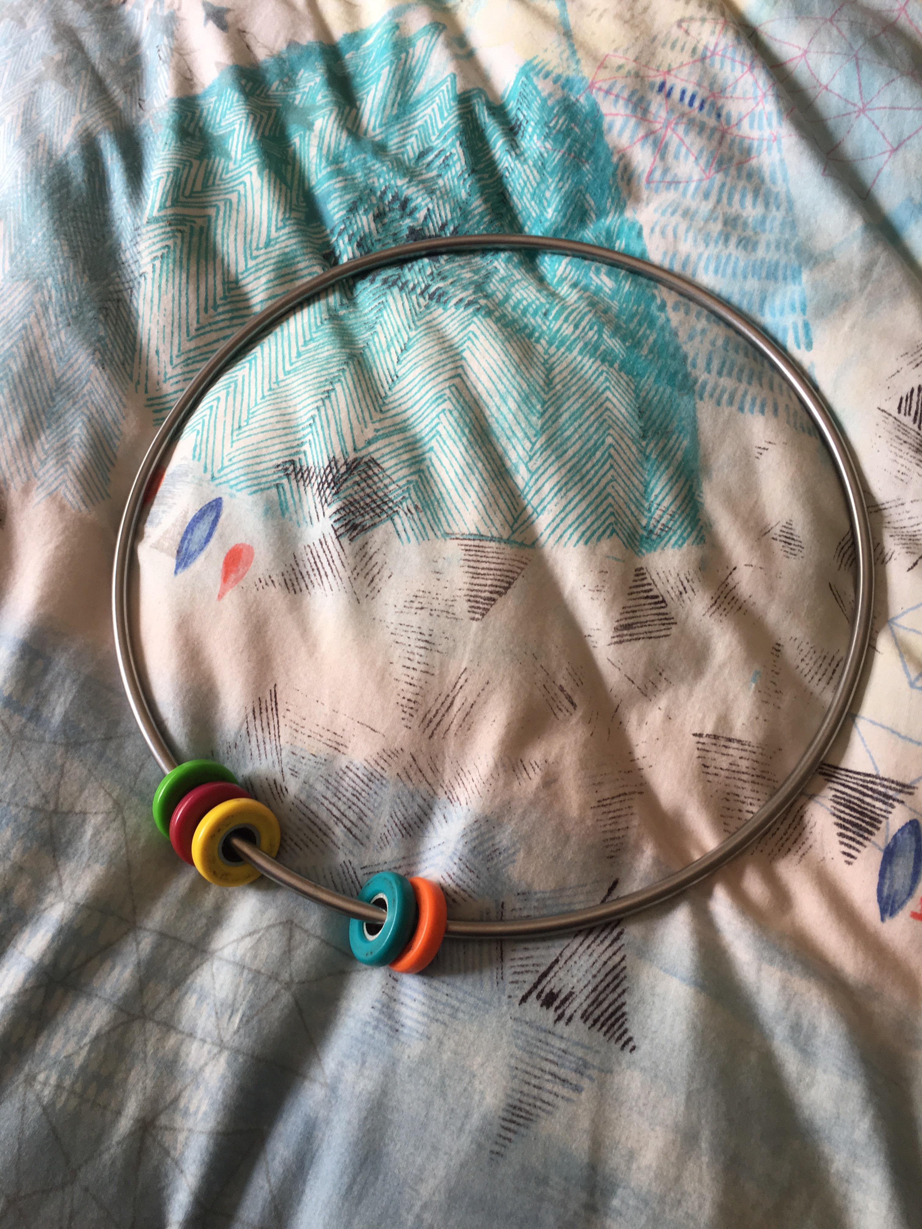 What's the name of this toy where you spin these small circles on the metal ring? They stay