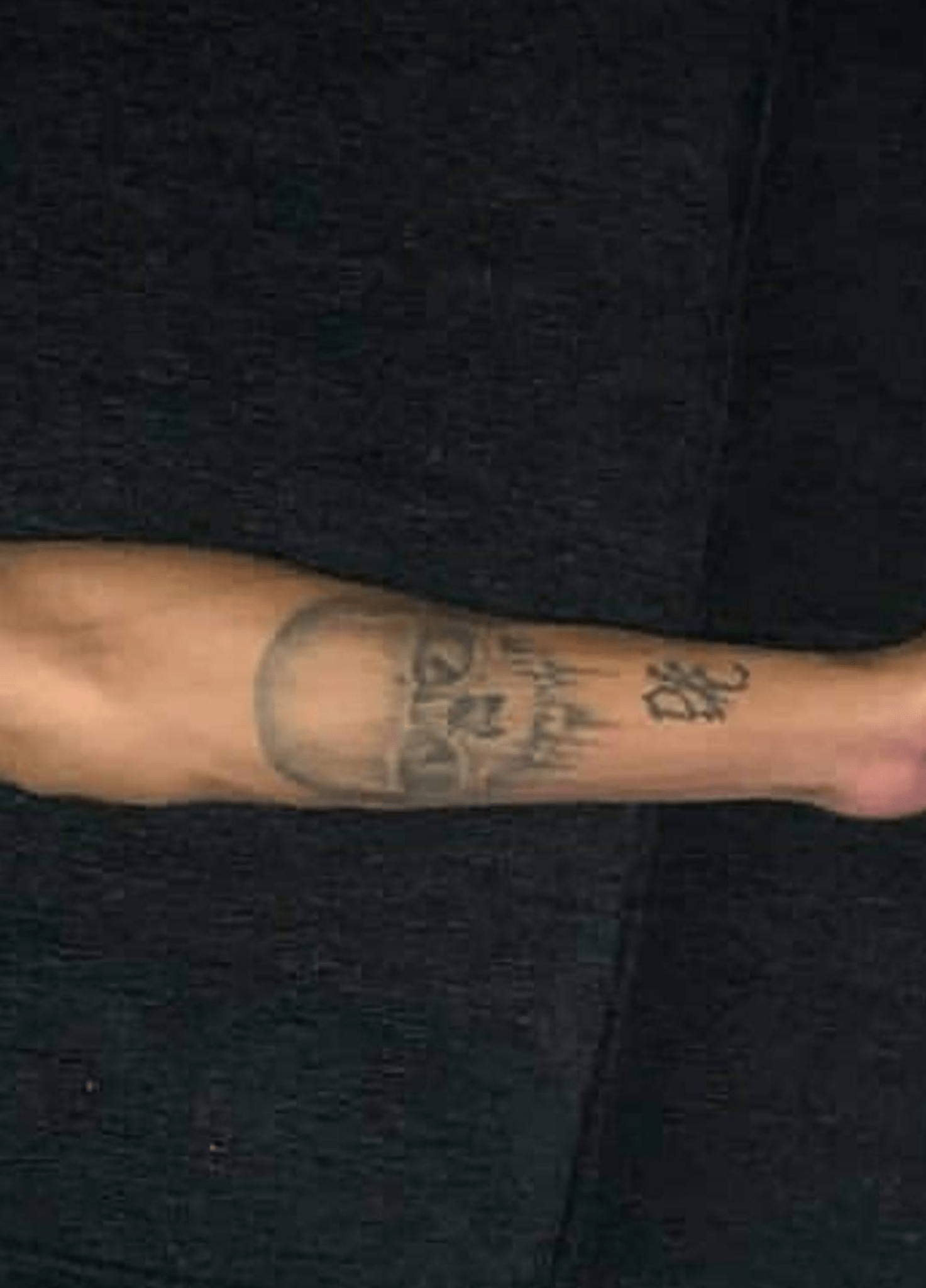 Was wondering. What does the tattoo below the skull say and whats the