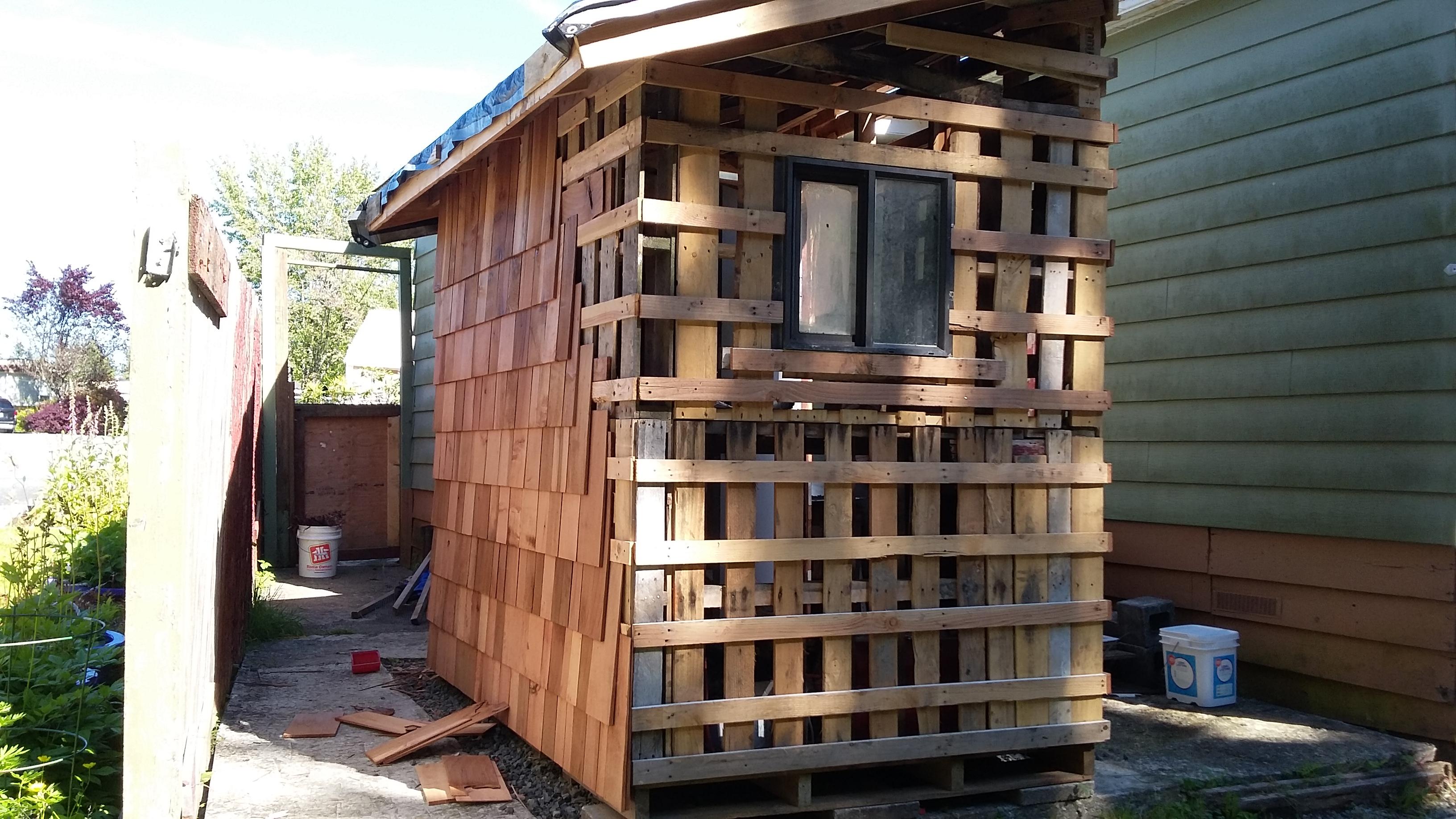 My pallet shed in progress, got shingles for really cheap as they are