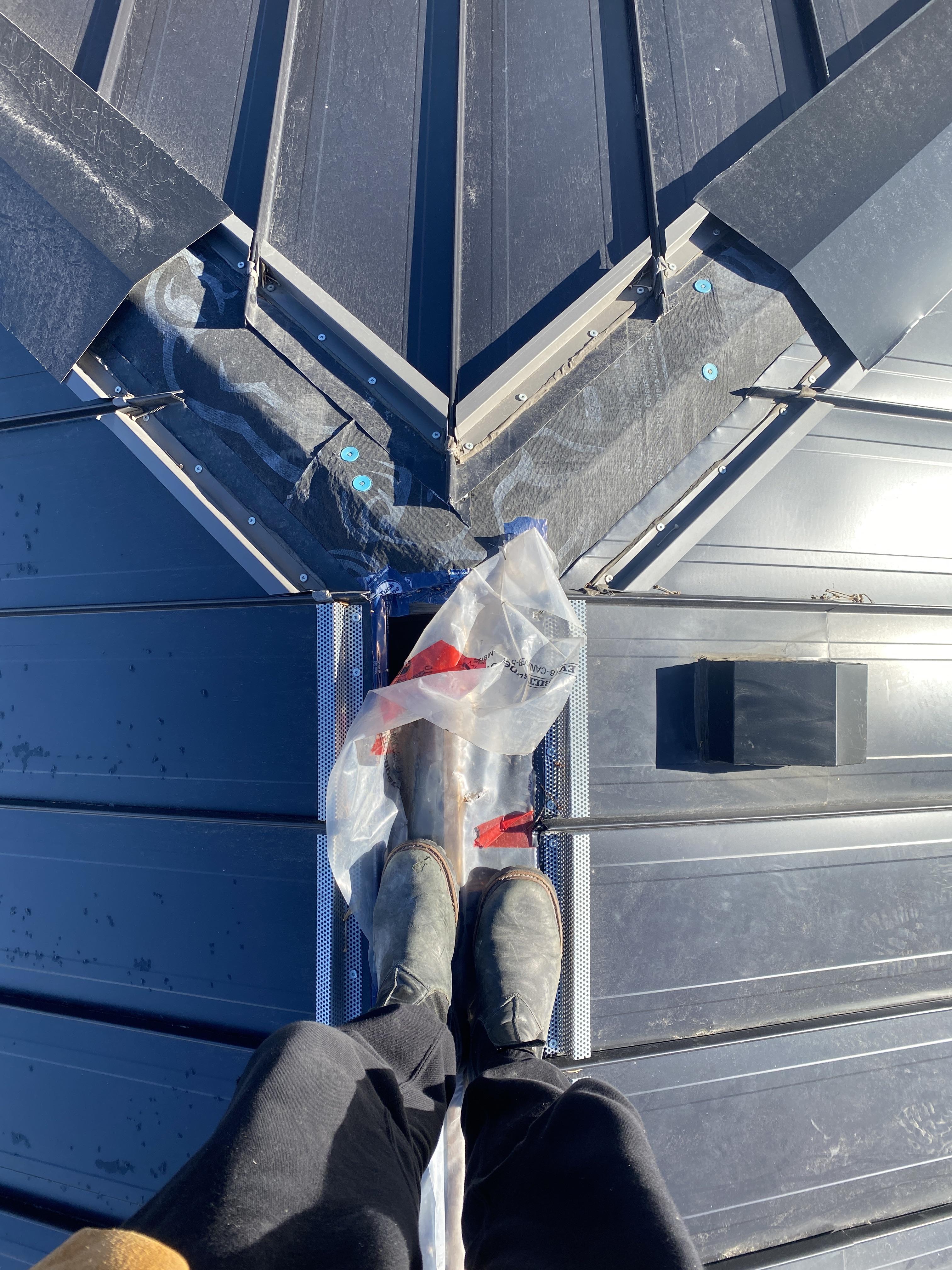 Hip to ridge detail on standing seam metal roof. r/Roofing