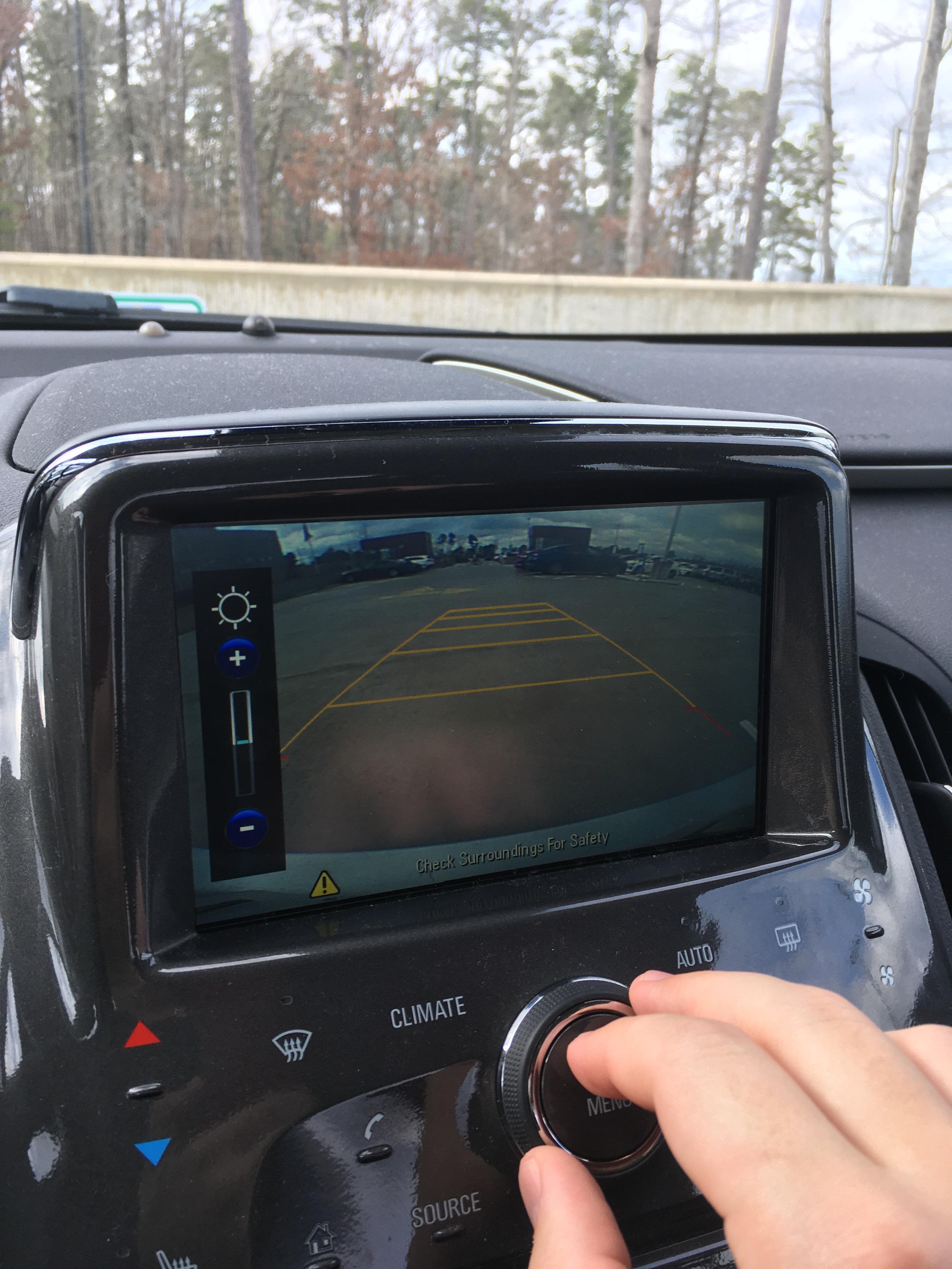 Found out you can adjust backup camera contrast/brightness by pushing