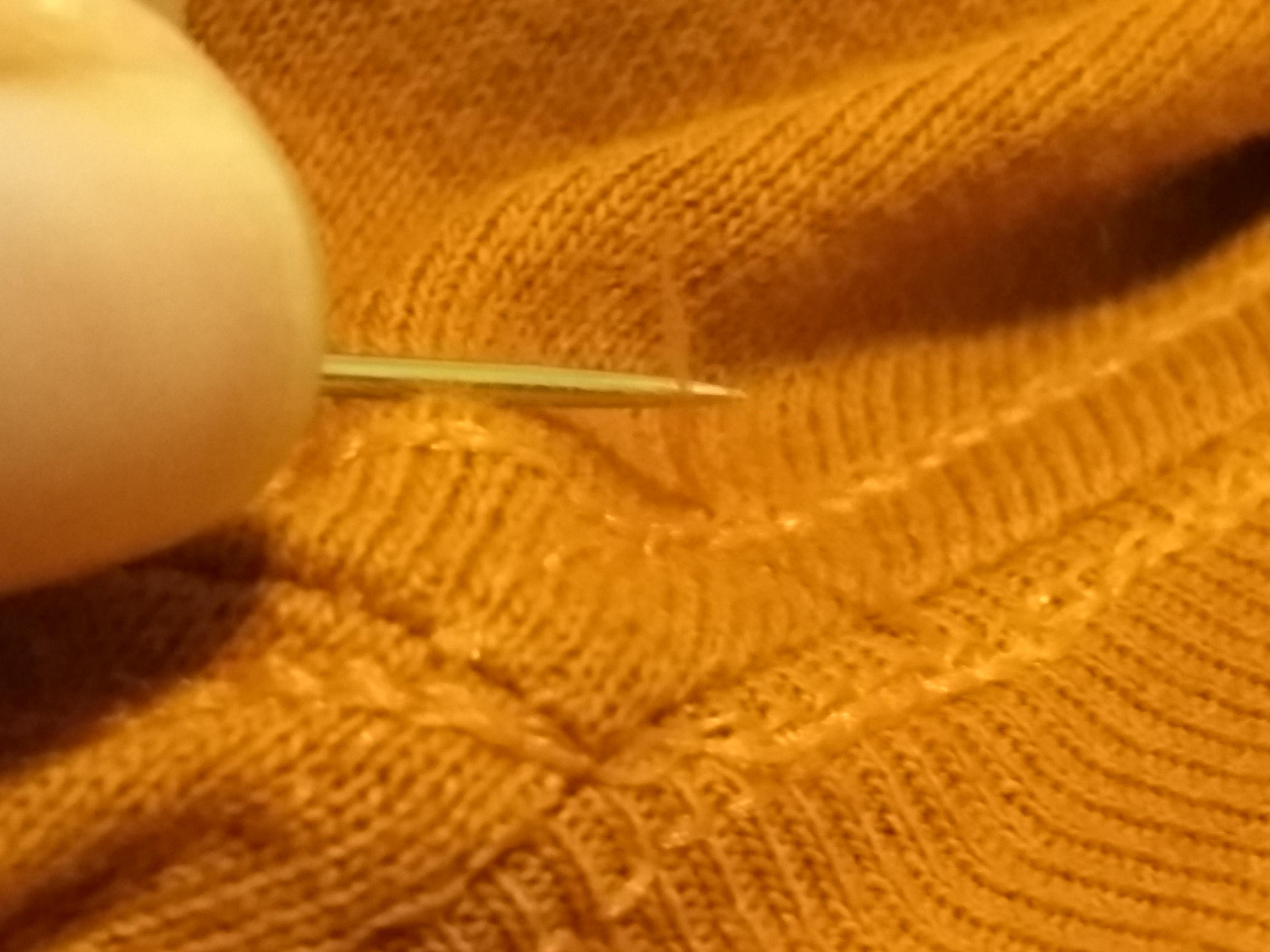 How do I stop the threads of a shirt's stitching from coming further
