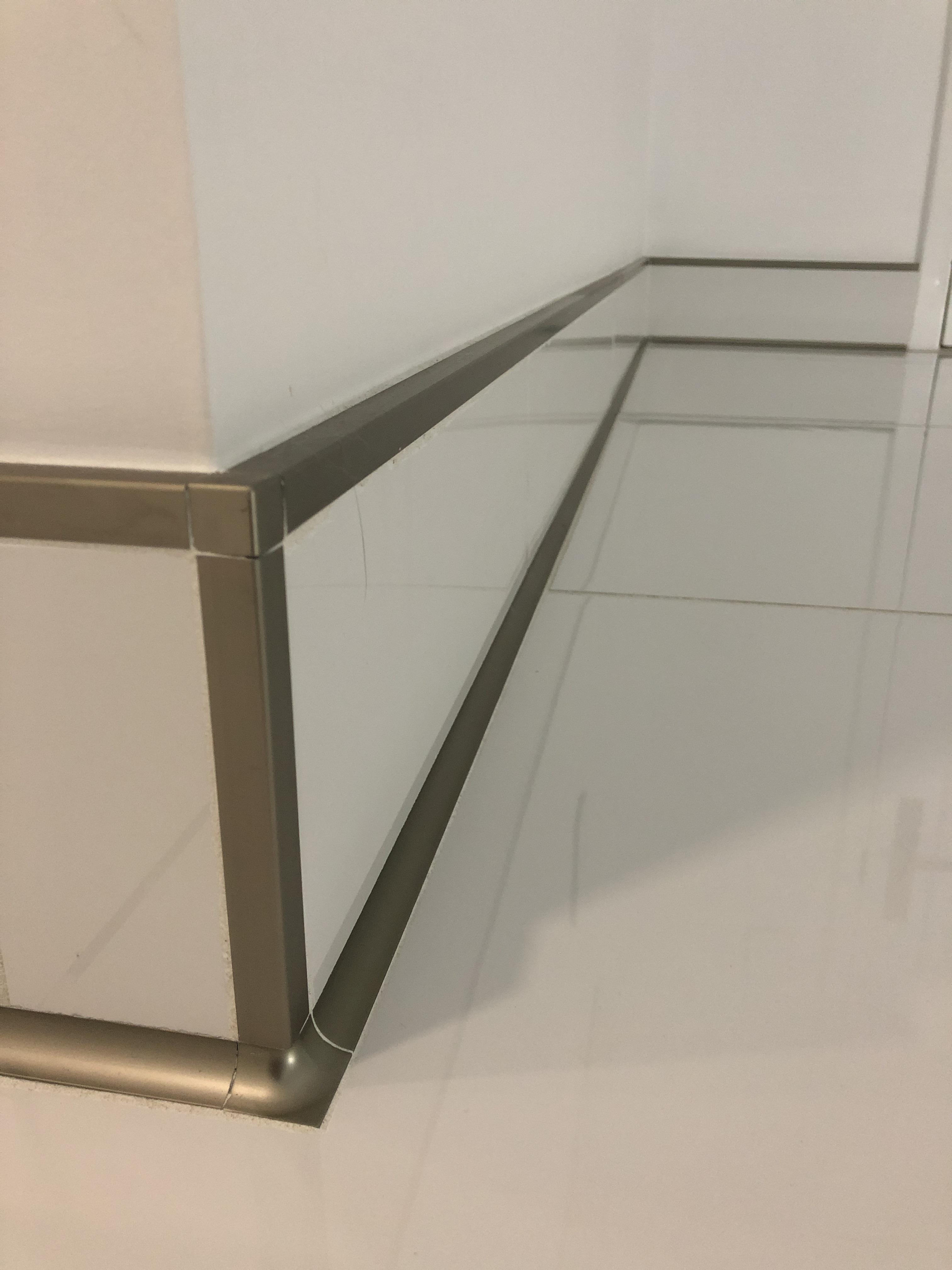 A close up of Schluter aluminum trim. This is the baseboard in my home