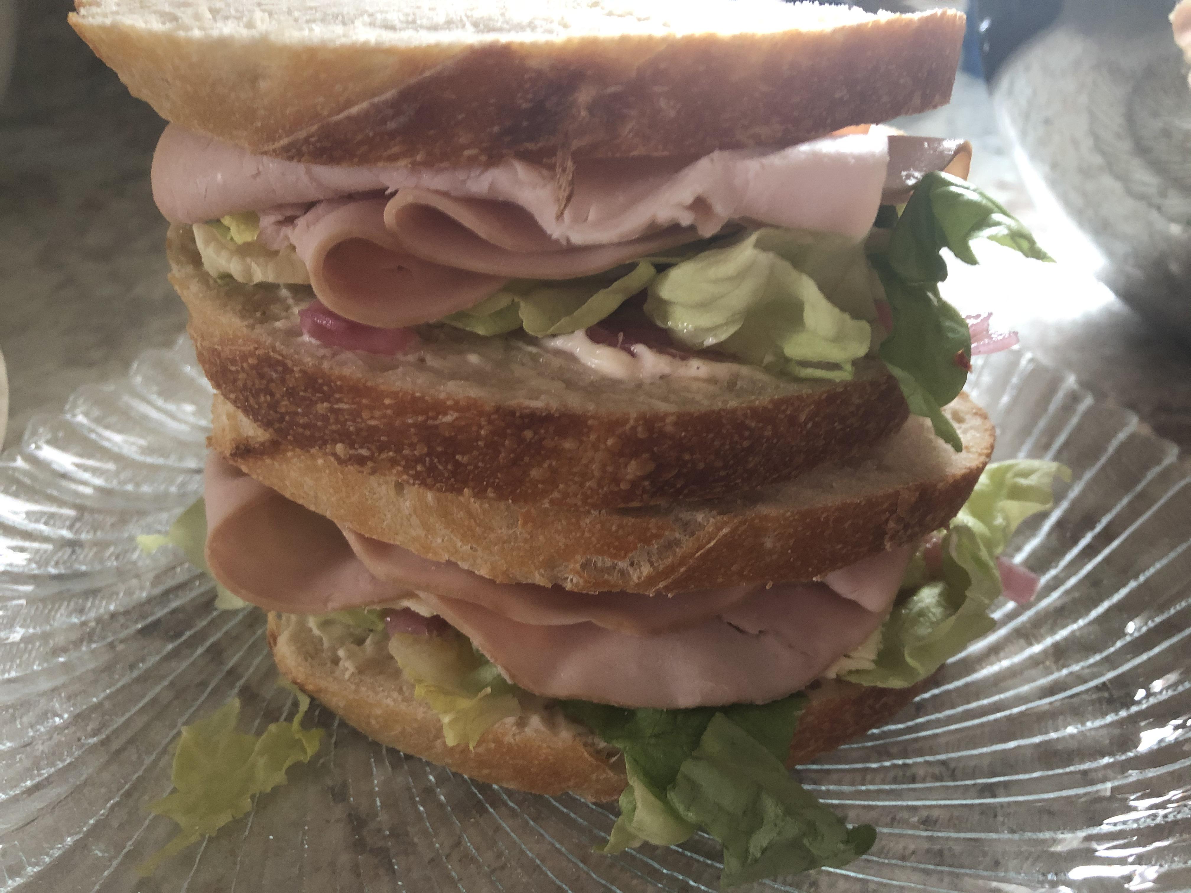 Turkey sandwich with butter lettuce, homemade pickled red onions and jalapeños, mayo and pepper