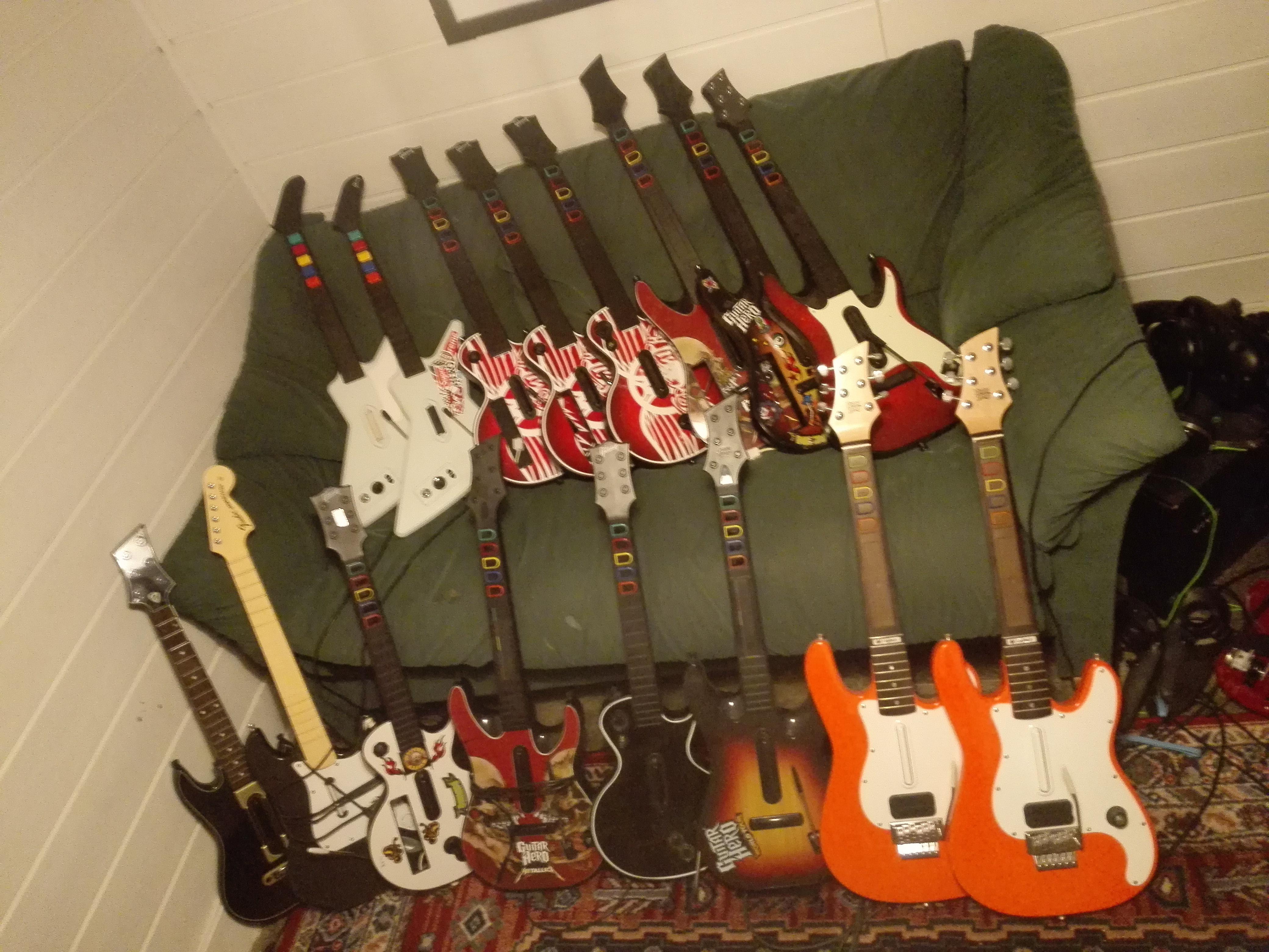 My collection of Guitar Hero guitars r/gamecollecting