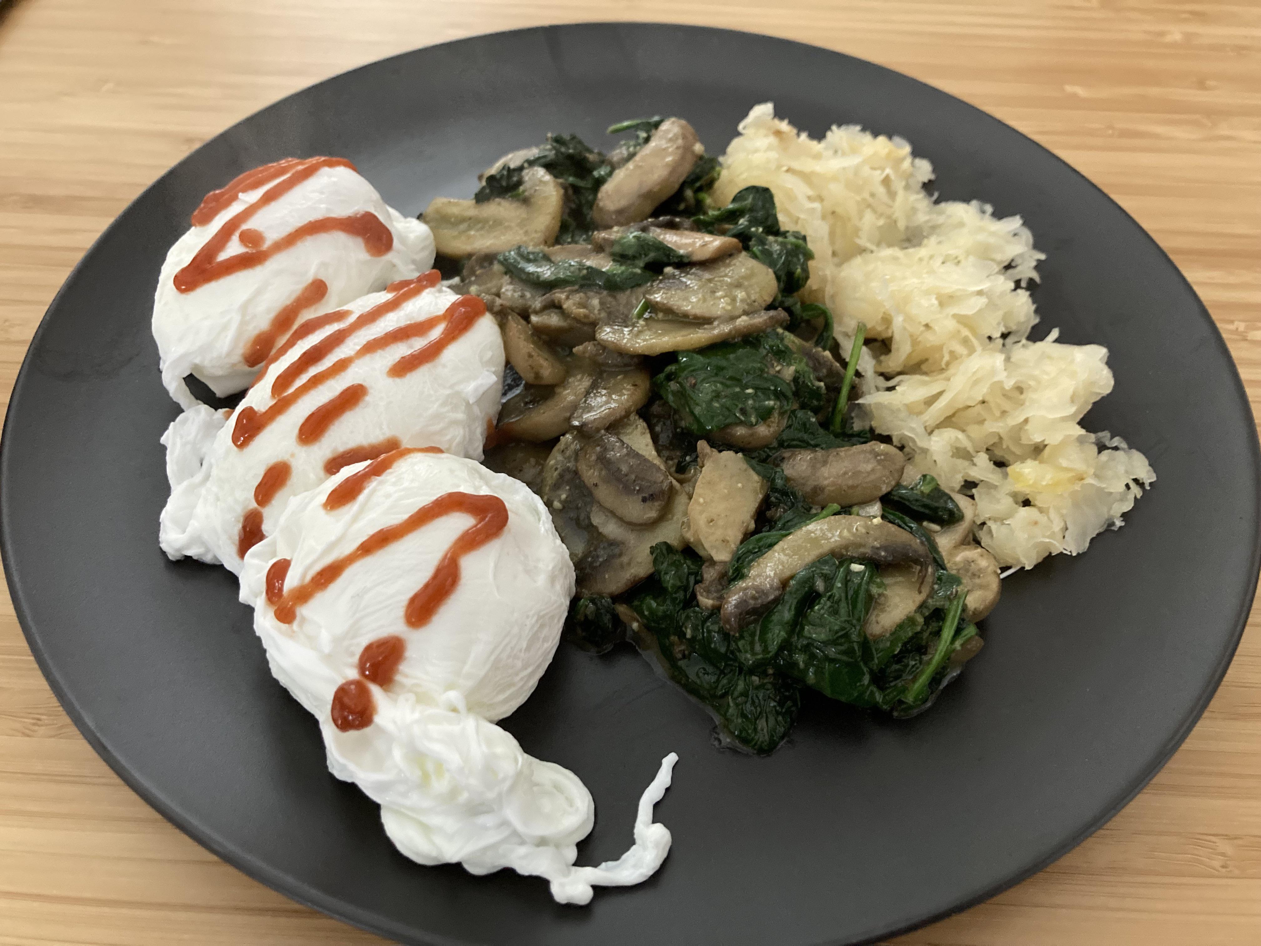 Poached eggs with sriracha, garlic butter mushrooms & spinach, and