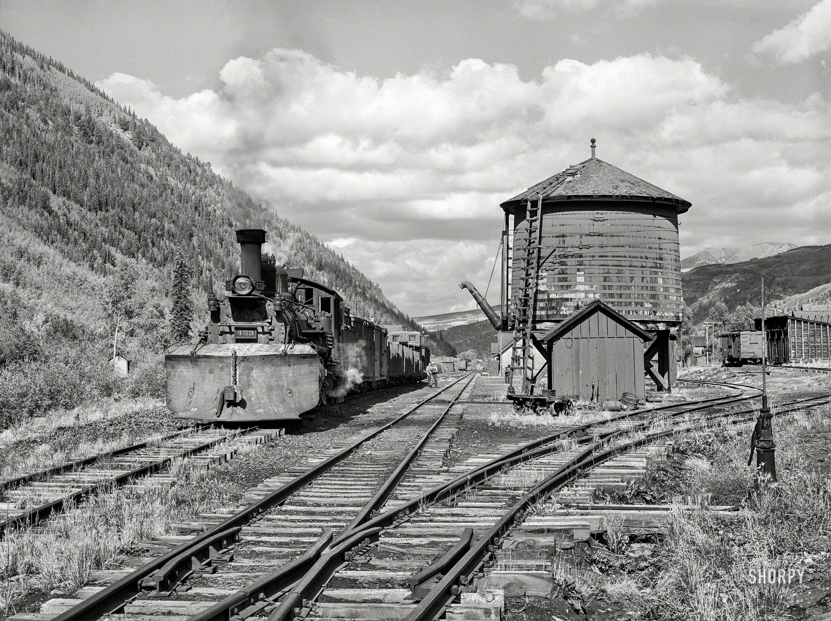 September 1940. "Narrow gauge railway yards, train and water tank at