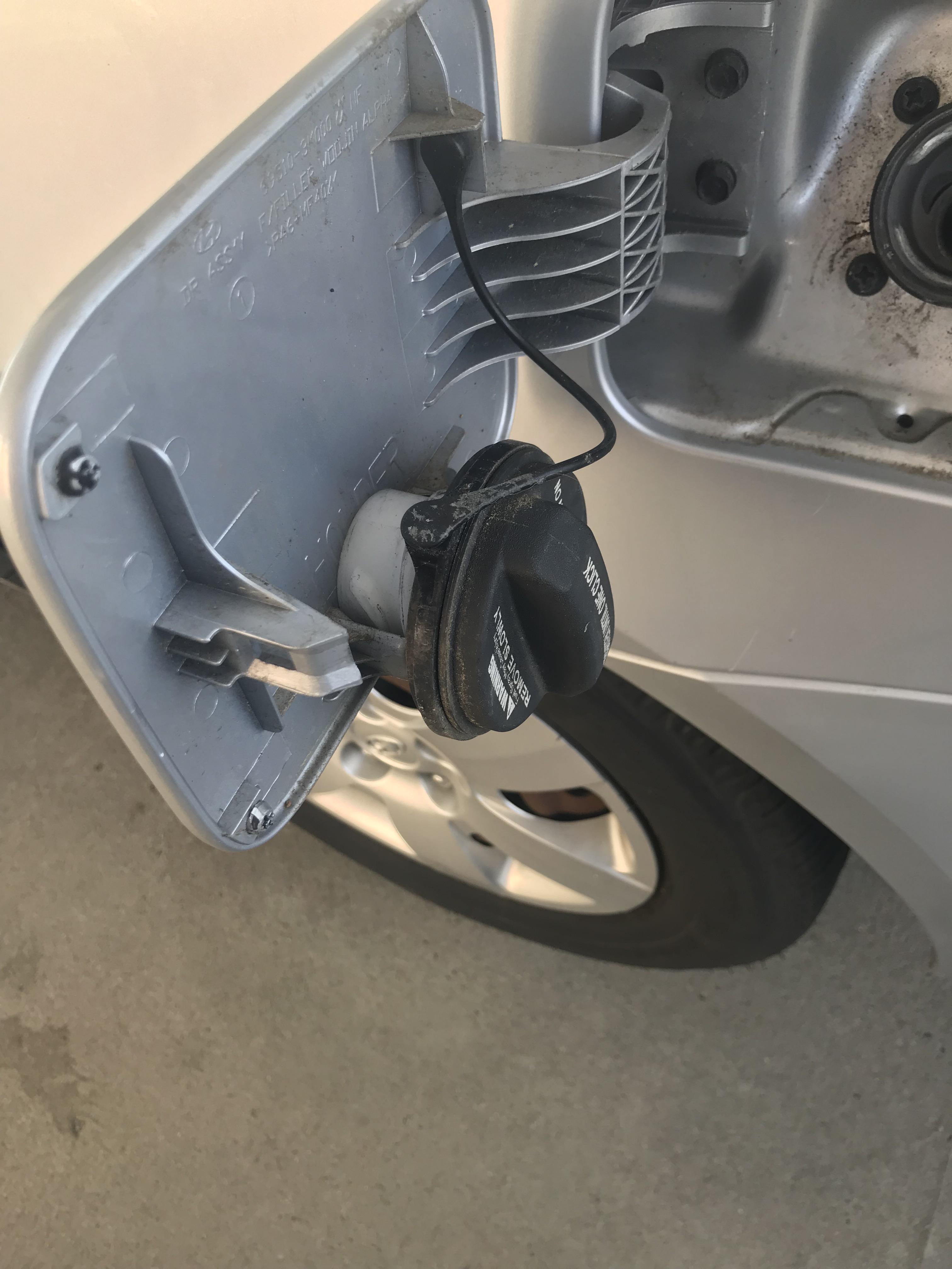 There’s a gas cap holder on the inside of the little gas cap door r