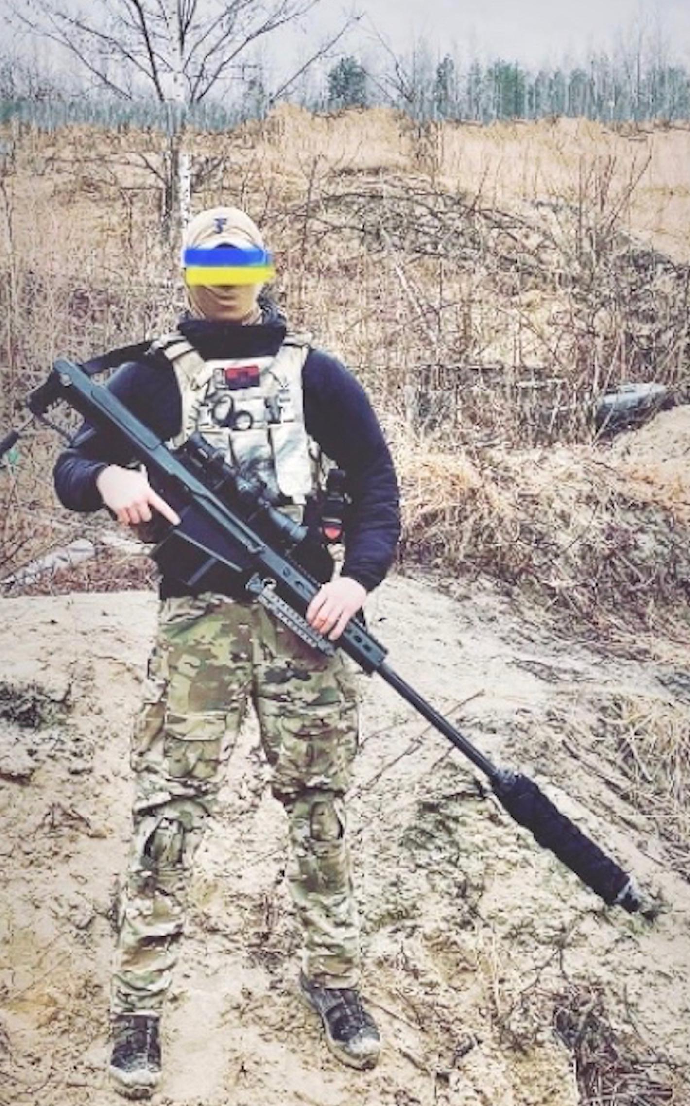 A volunteer from the UK with a suppressed Barrett M107 antimateriel