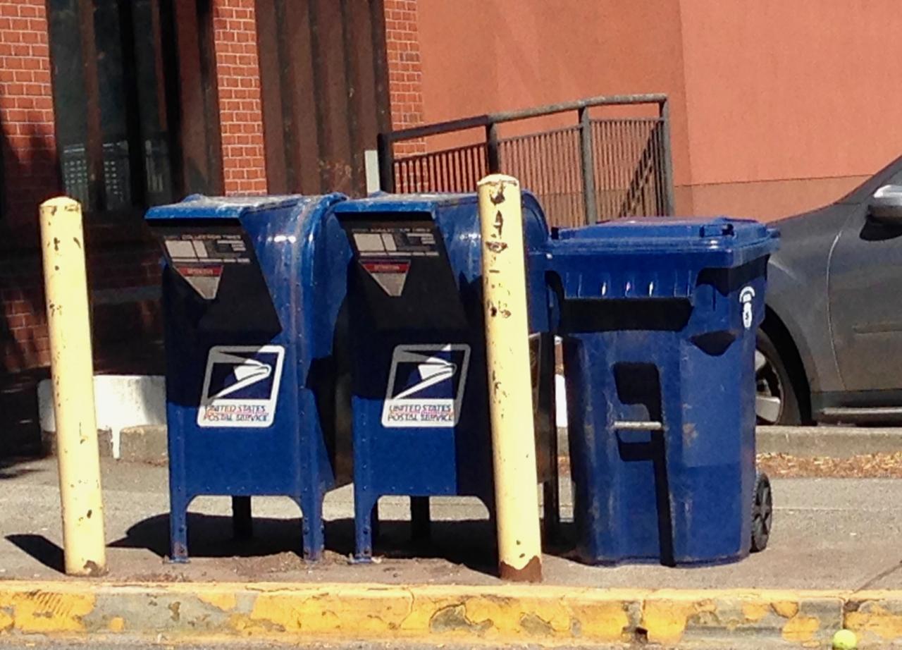 This recycling bin is the exact same color as these mailboxes. r