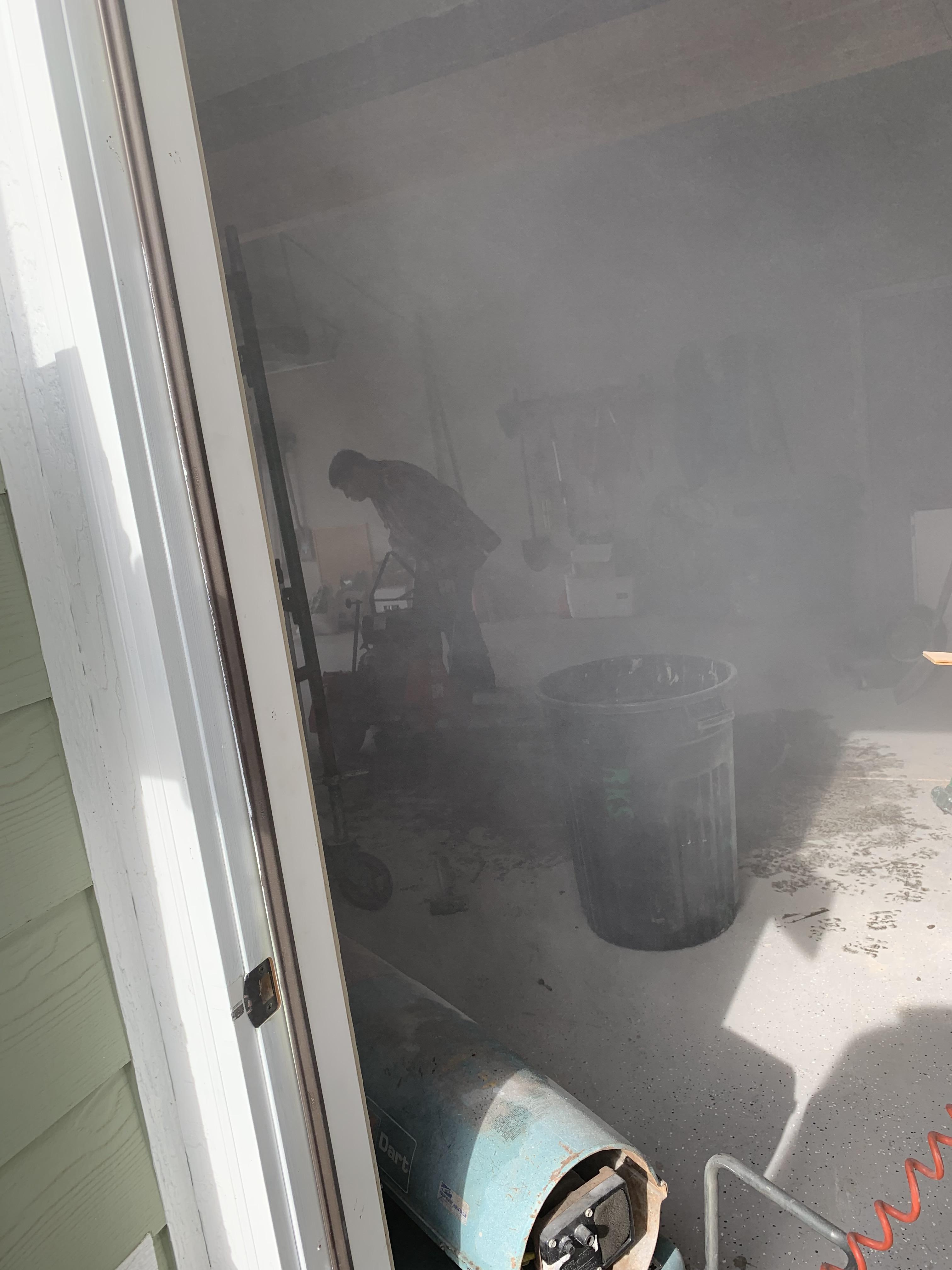 Cutting concrete in a garage, No mask, No ear protection, and No