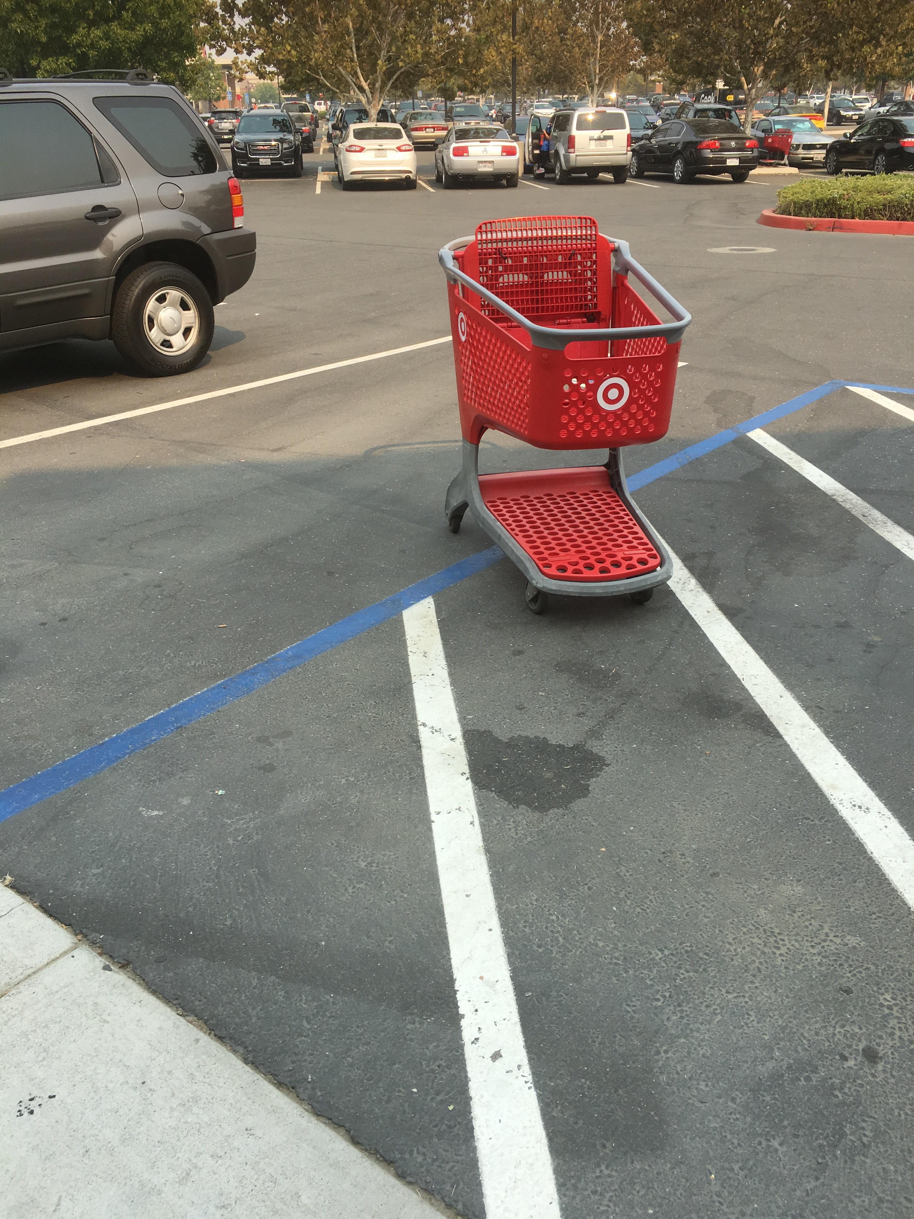 People leaving a shopping cart in a handicap parking spot far away from