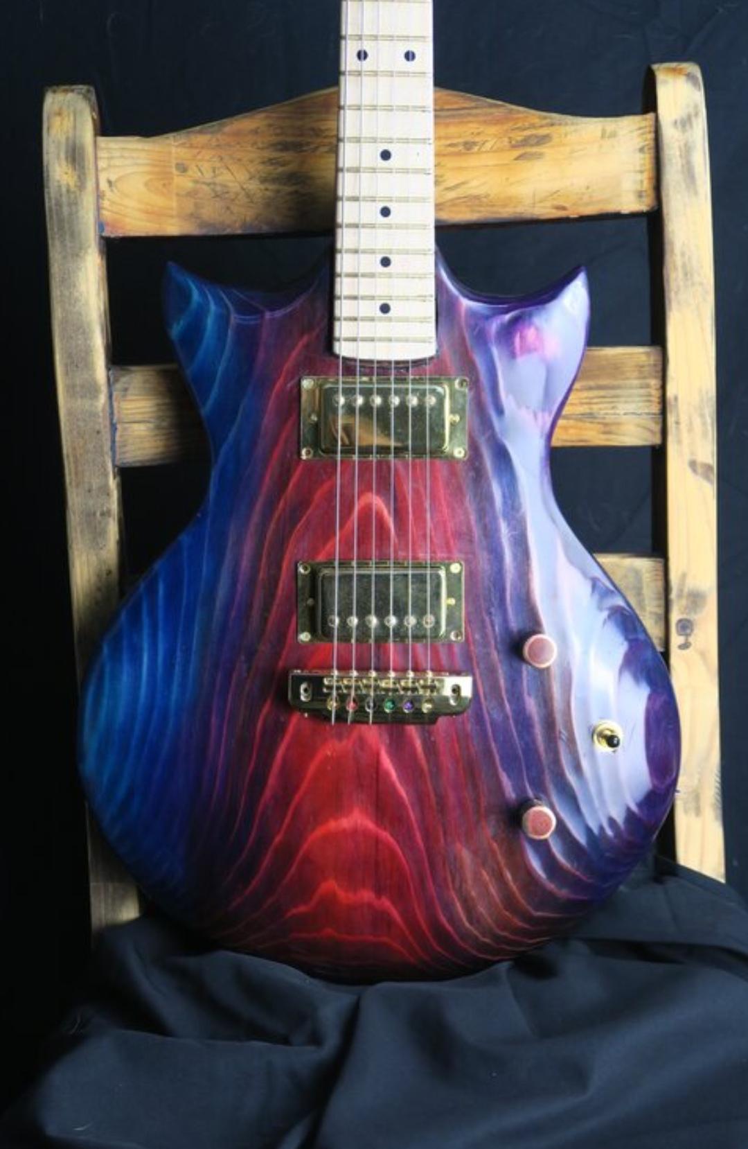 My friend makes the most beautiful handmade guitars and is trying to