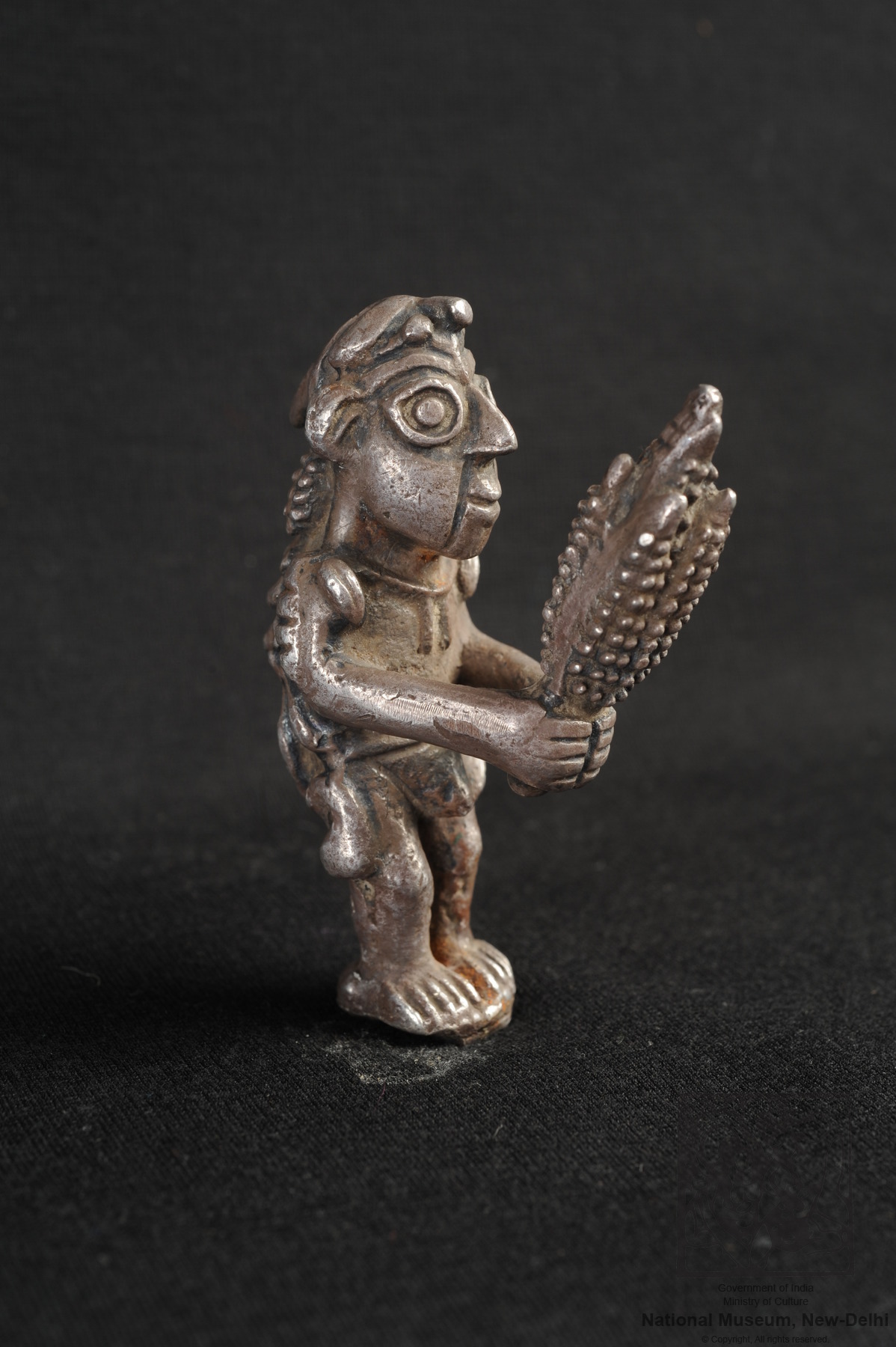 Solid silver statue of a human holding a corn cob, 11001400 CE, Chimu Culture, Peru. On display
