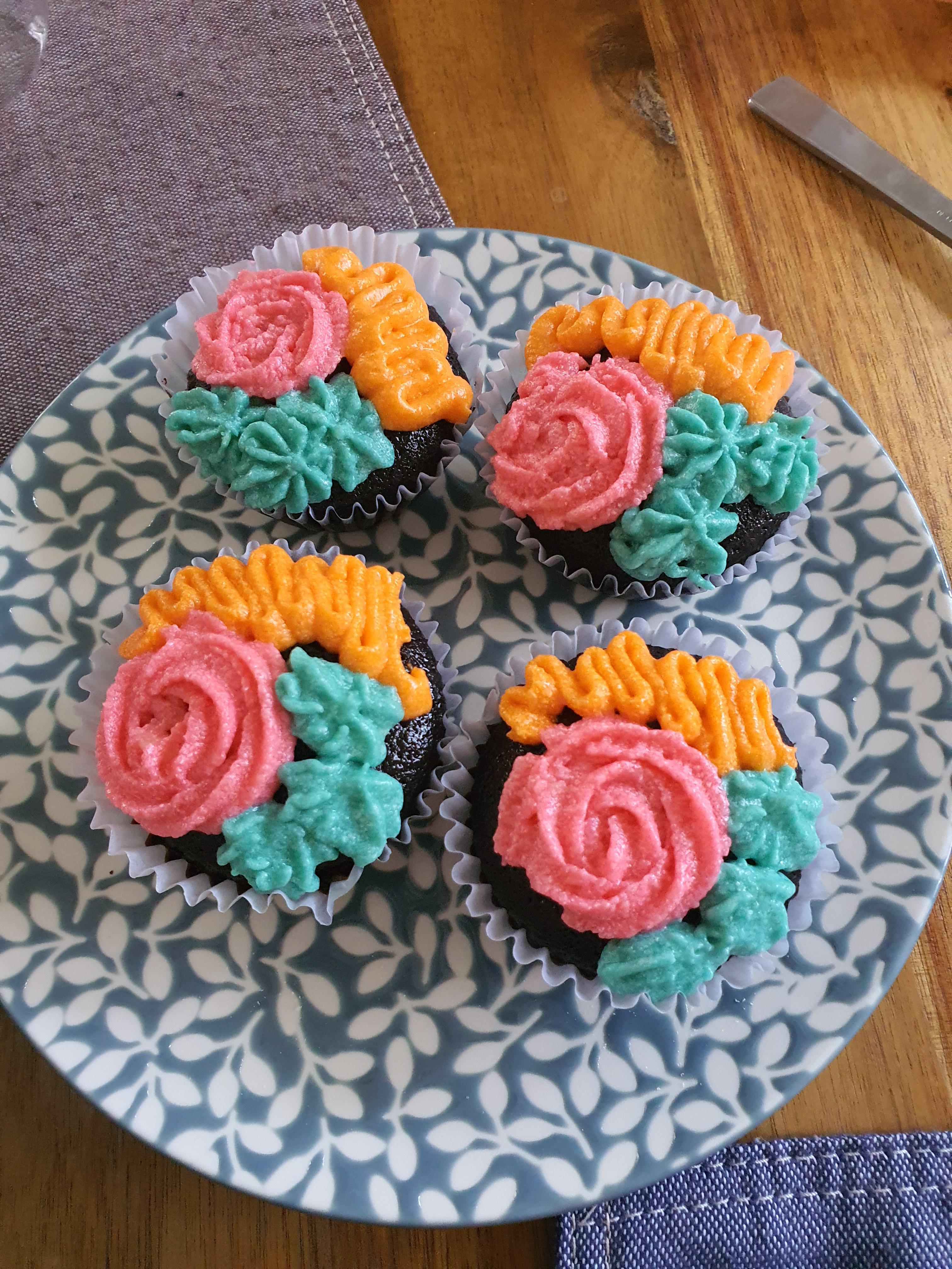 Chocolate cupcakes with grainy melty cream cheese frosting. Tropical