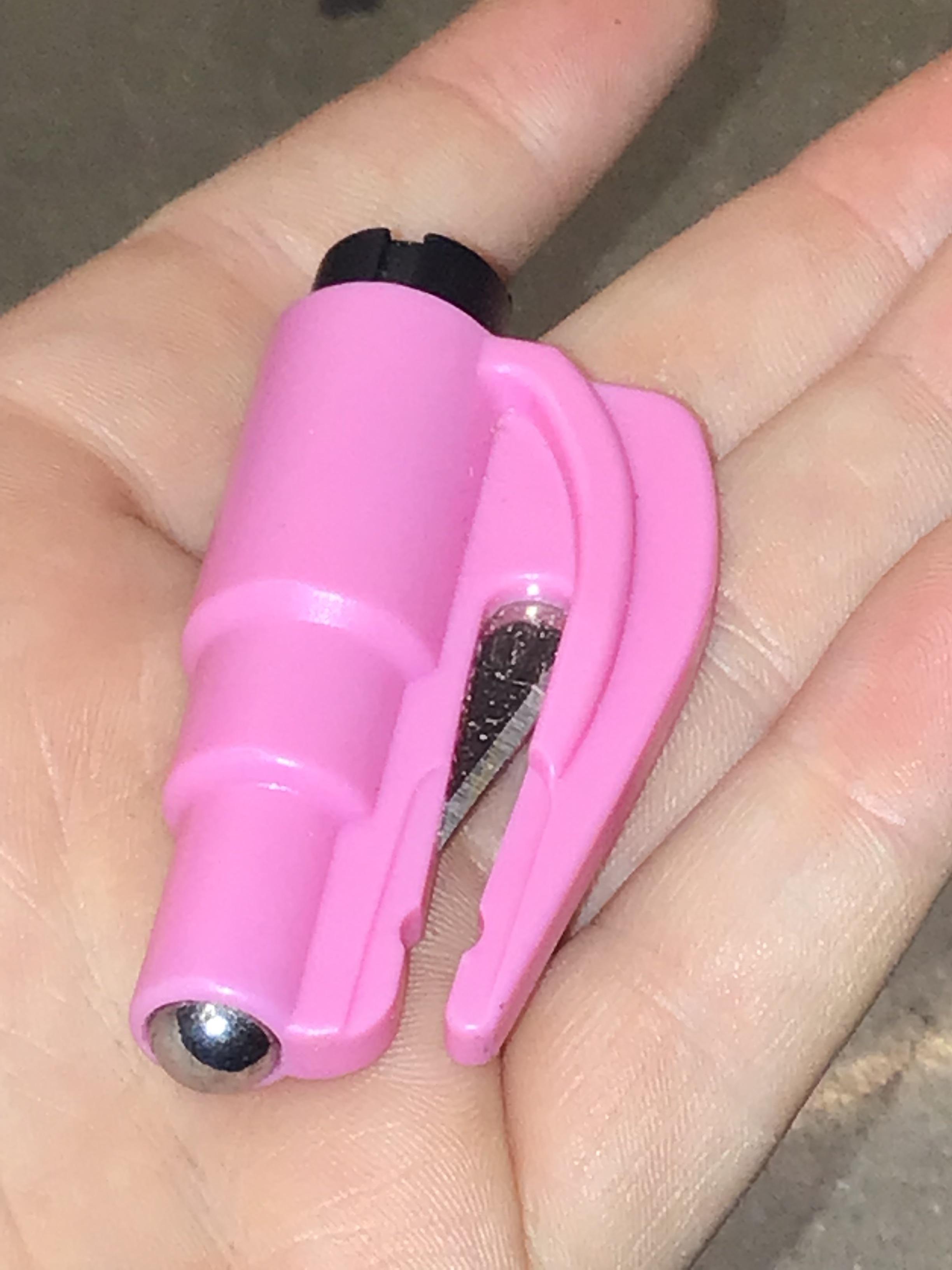 Window breaker and seat belt cutter. It is missing the keychain clip