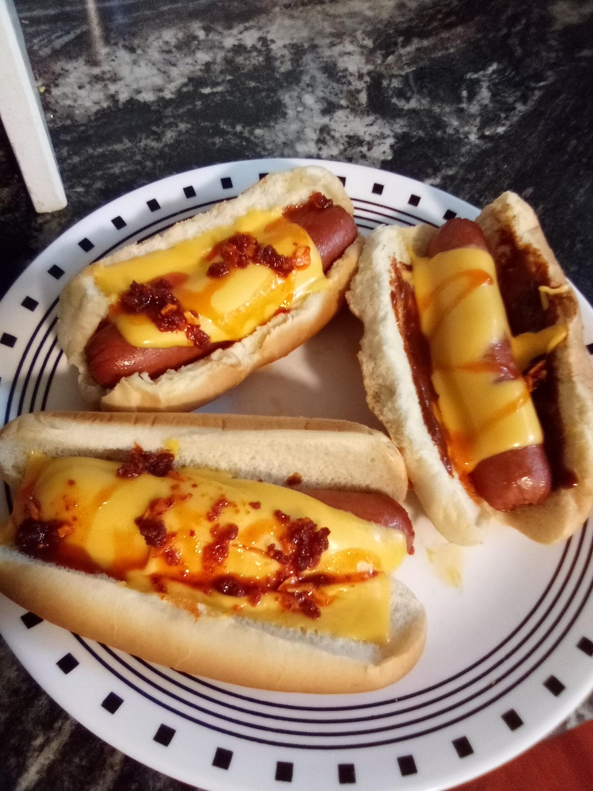 Microwaved hot dogs with Kraft singles and various condimentshot