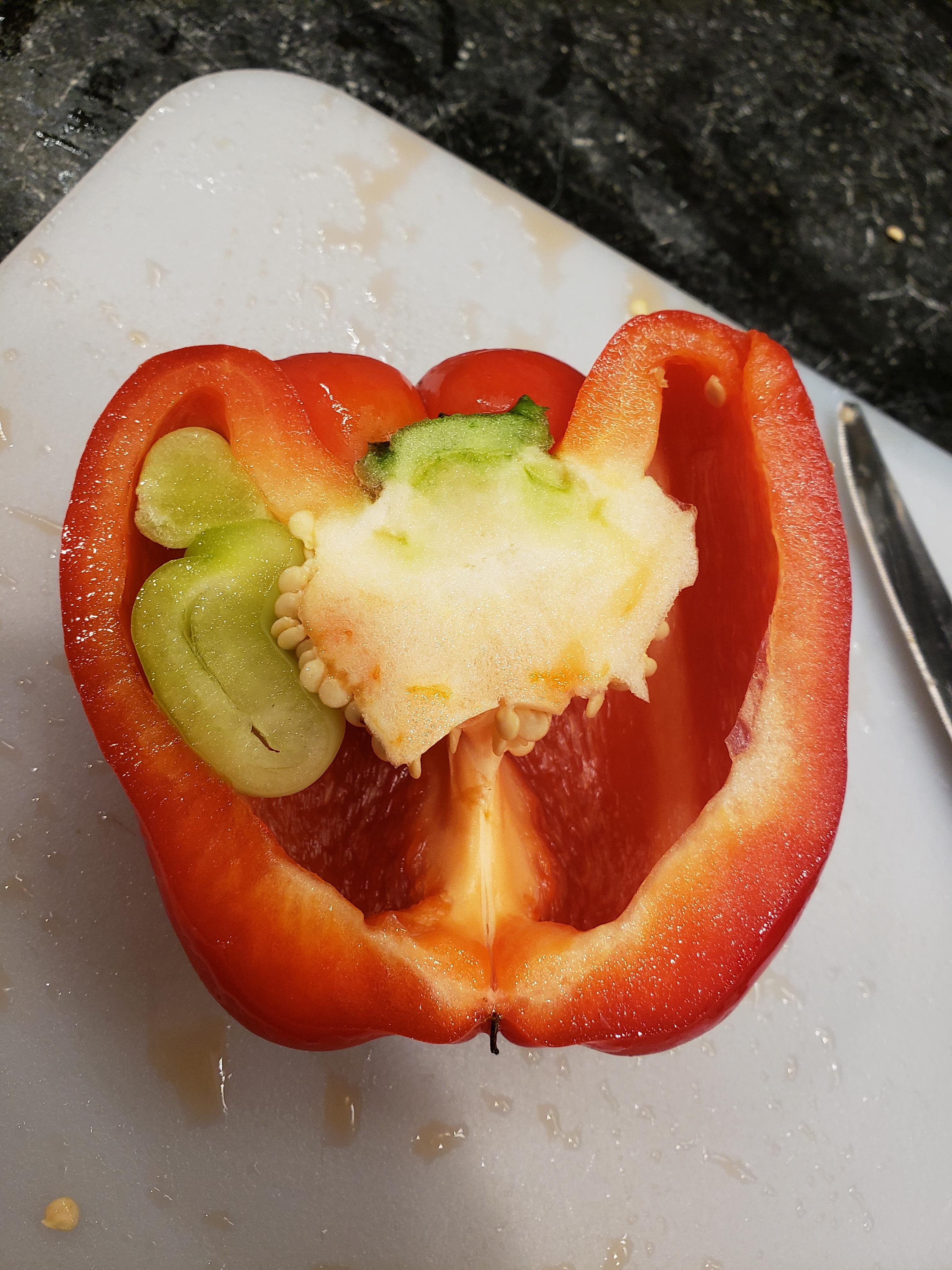 This baby green pepper growing in mama red pepper r/mildlyinteresting