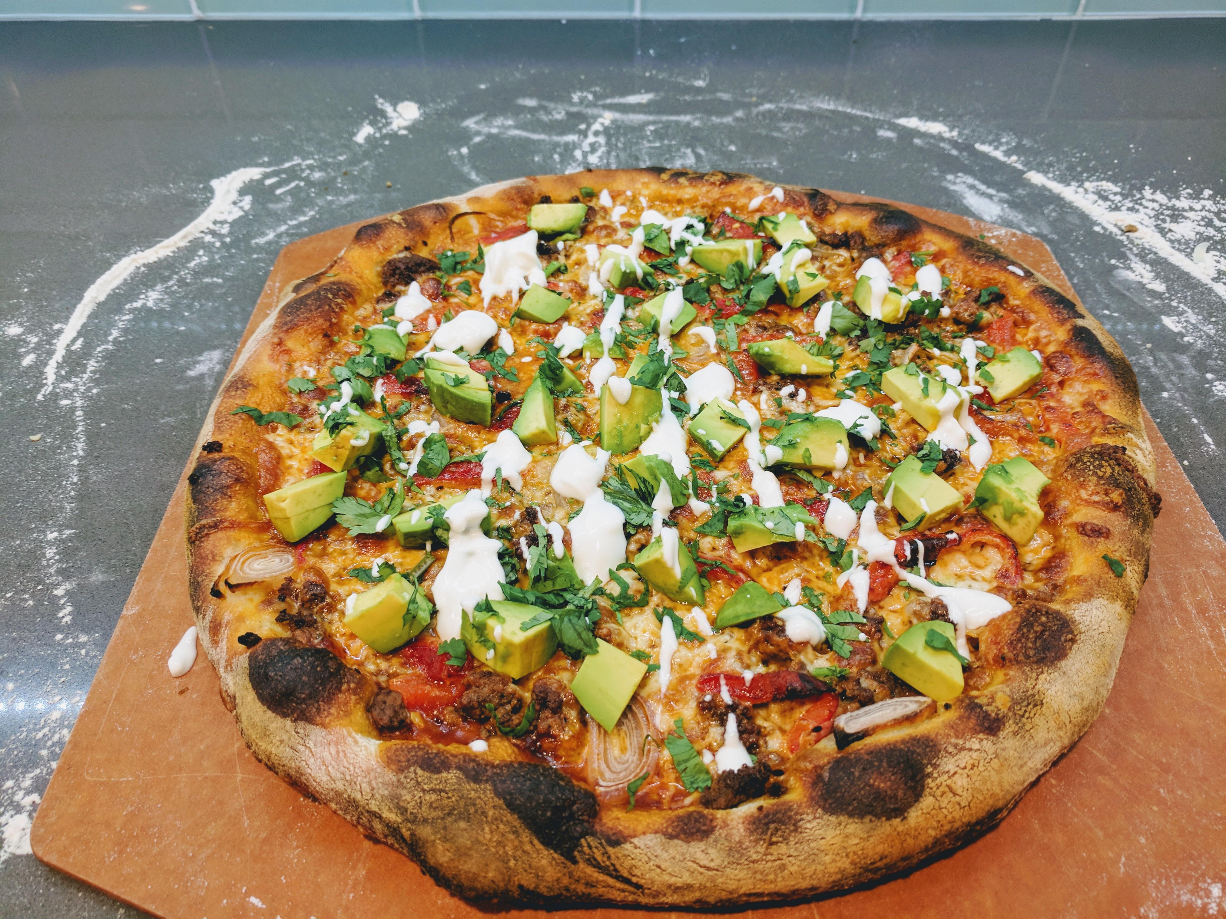 Mexican pizza with NY style dough. Enchilada sauce, taco meat, roasted