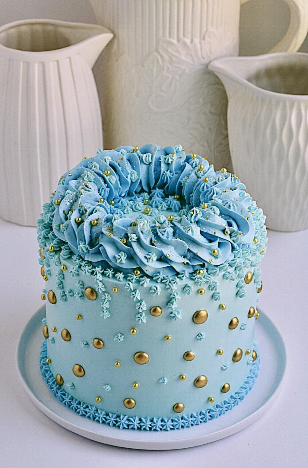 This is a chocolate layer cake with vanilla buttercream. I painted