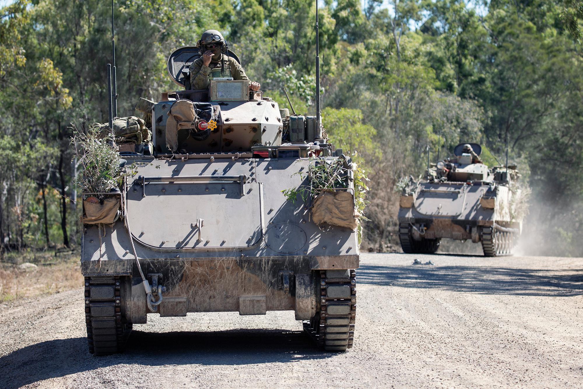 Australian Army M113 armoured personnel carriers conducting a patrol