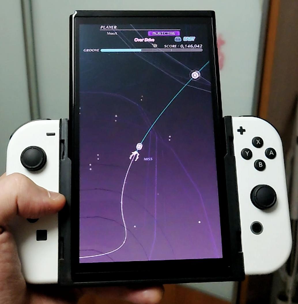 The Flip Grip still fits the Switch OLED and Groove Coaster looks