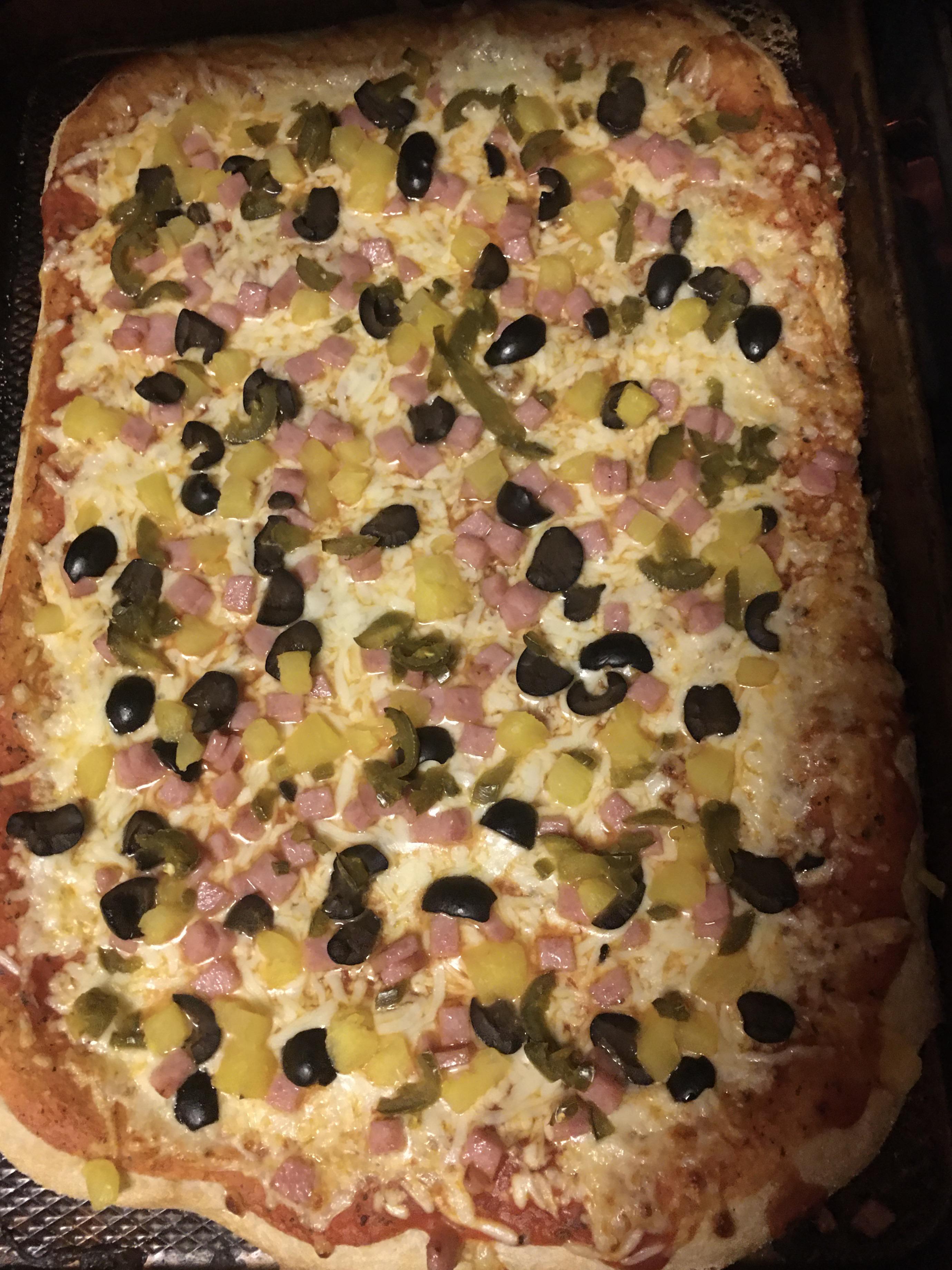 Home made pizza pineapple, jalapeño, pork roll and black olives. r