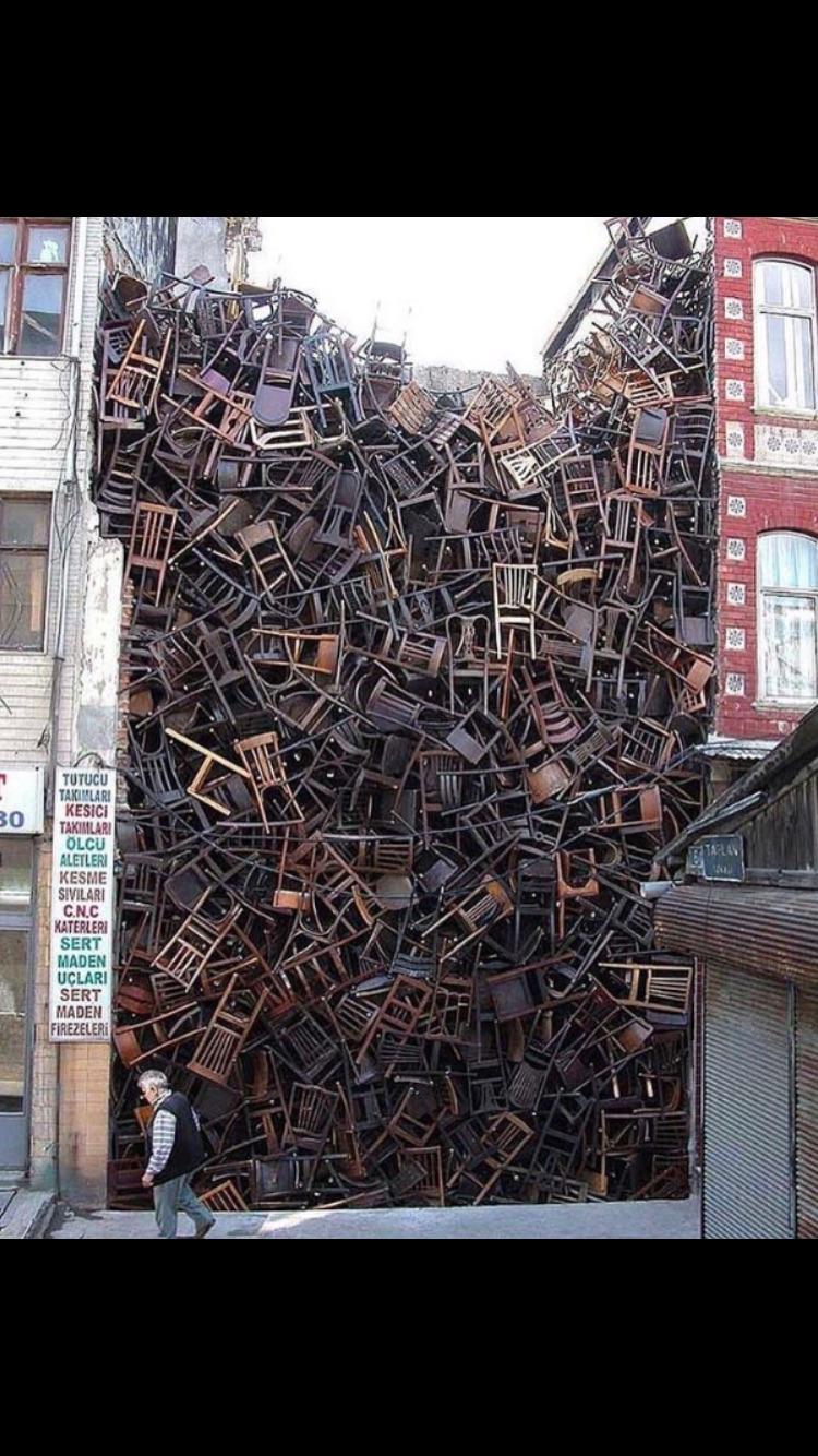 1550 chairs stacked between two buildings by Doris Salcedo r/Art