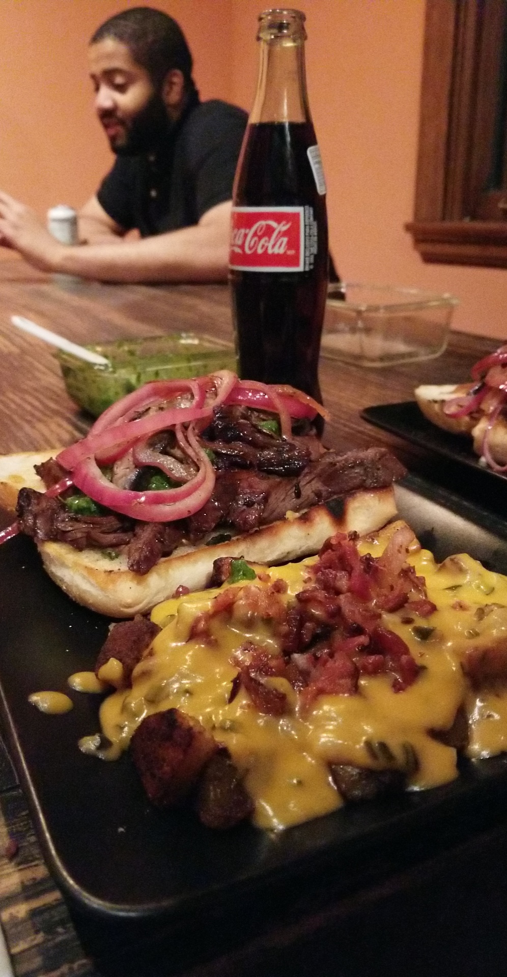 Skirt steak sandwich with chimichurri and pickled red onions. Side of