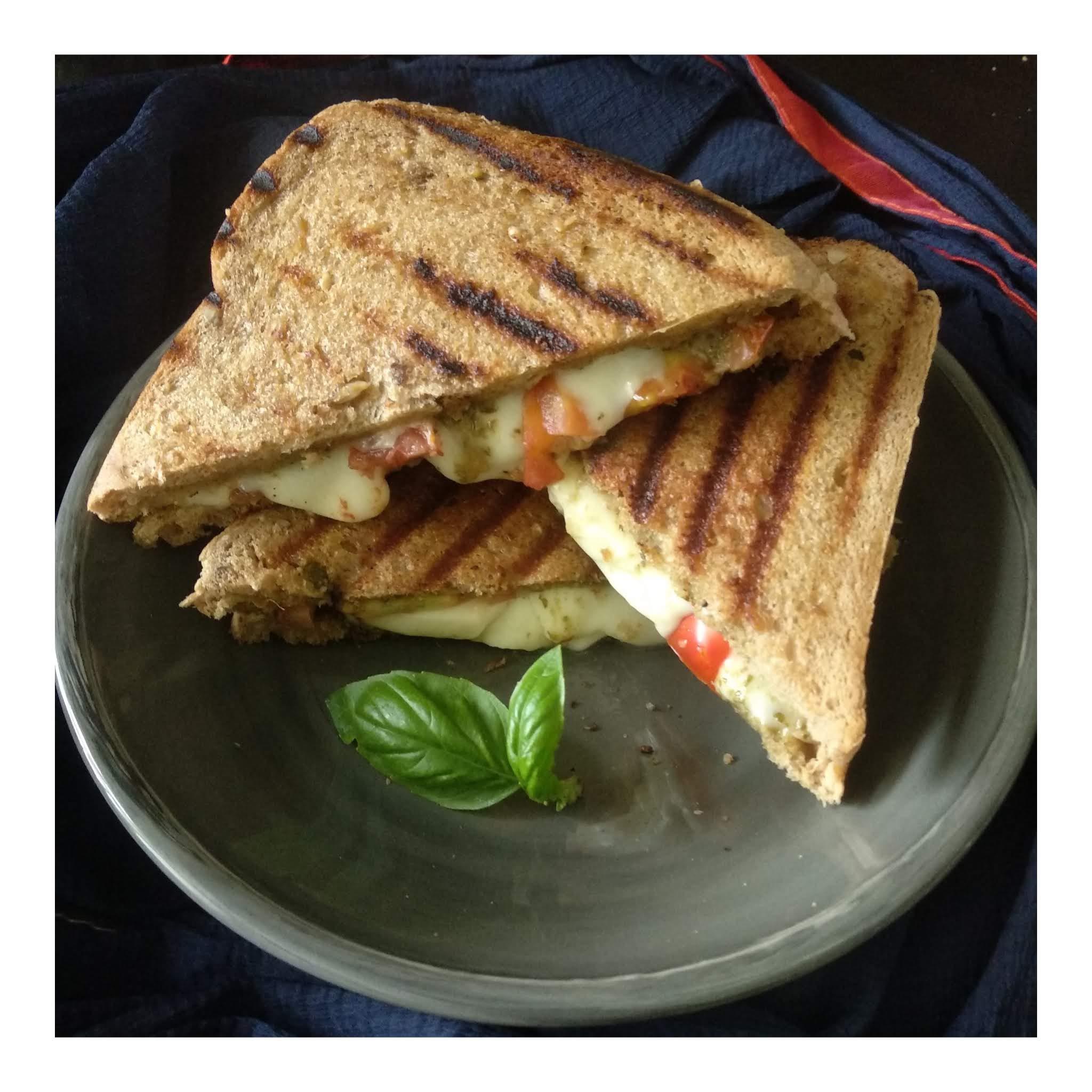 Made a caprese grilled cheese with pesto, mozzarella and tomatoes. r