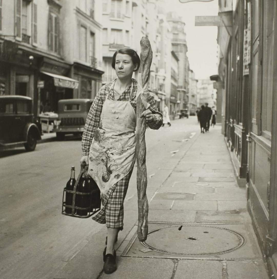 A French woman with her baguette and six bottles of wine, Paris, France