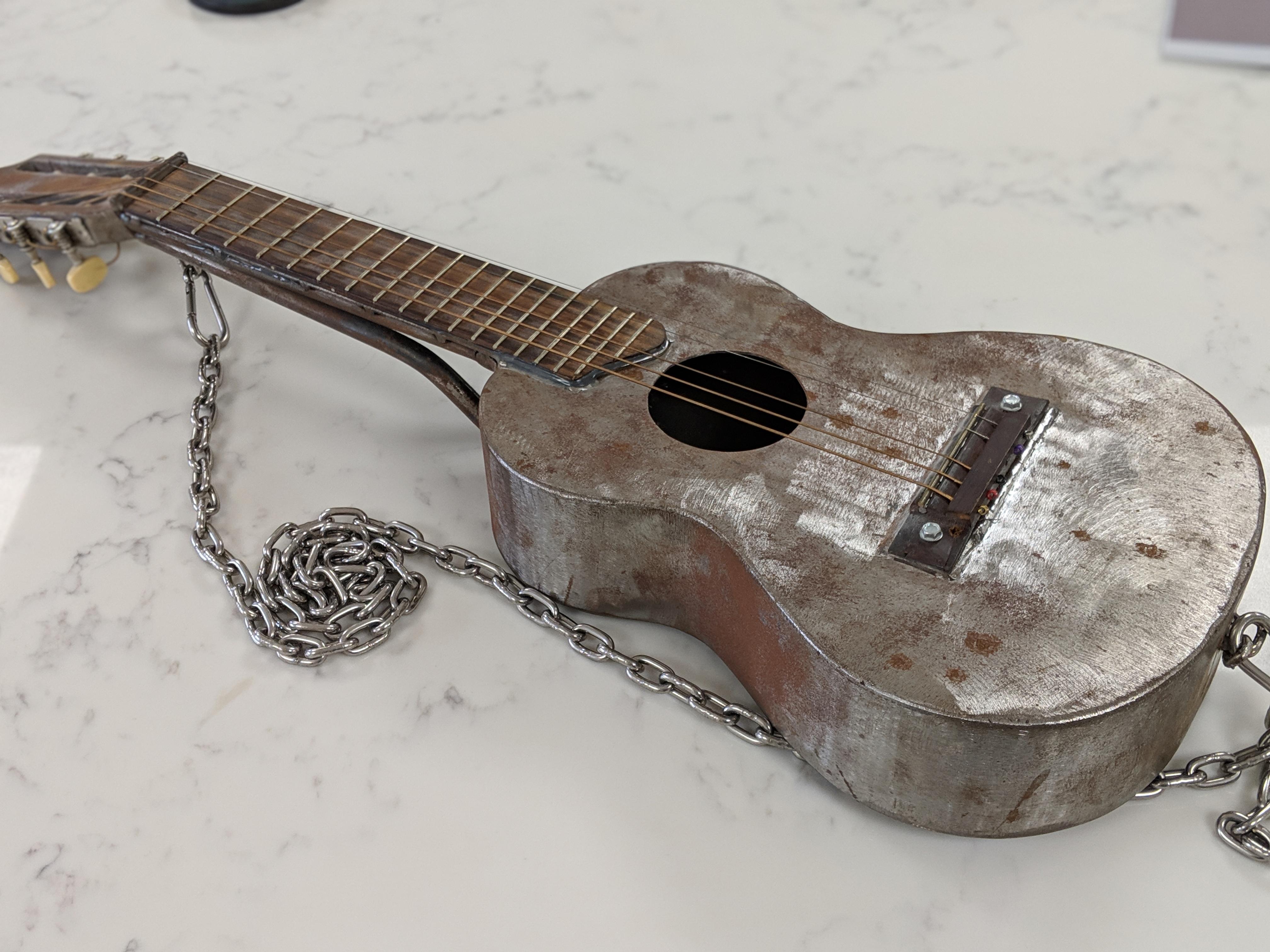 This solid Steel acoustic guitar my colleague's son made r