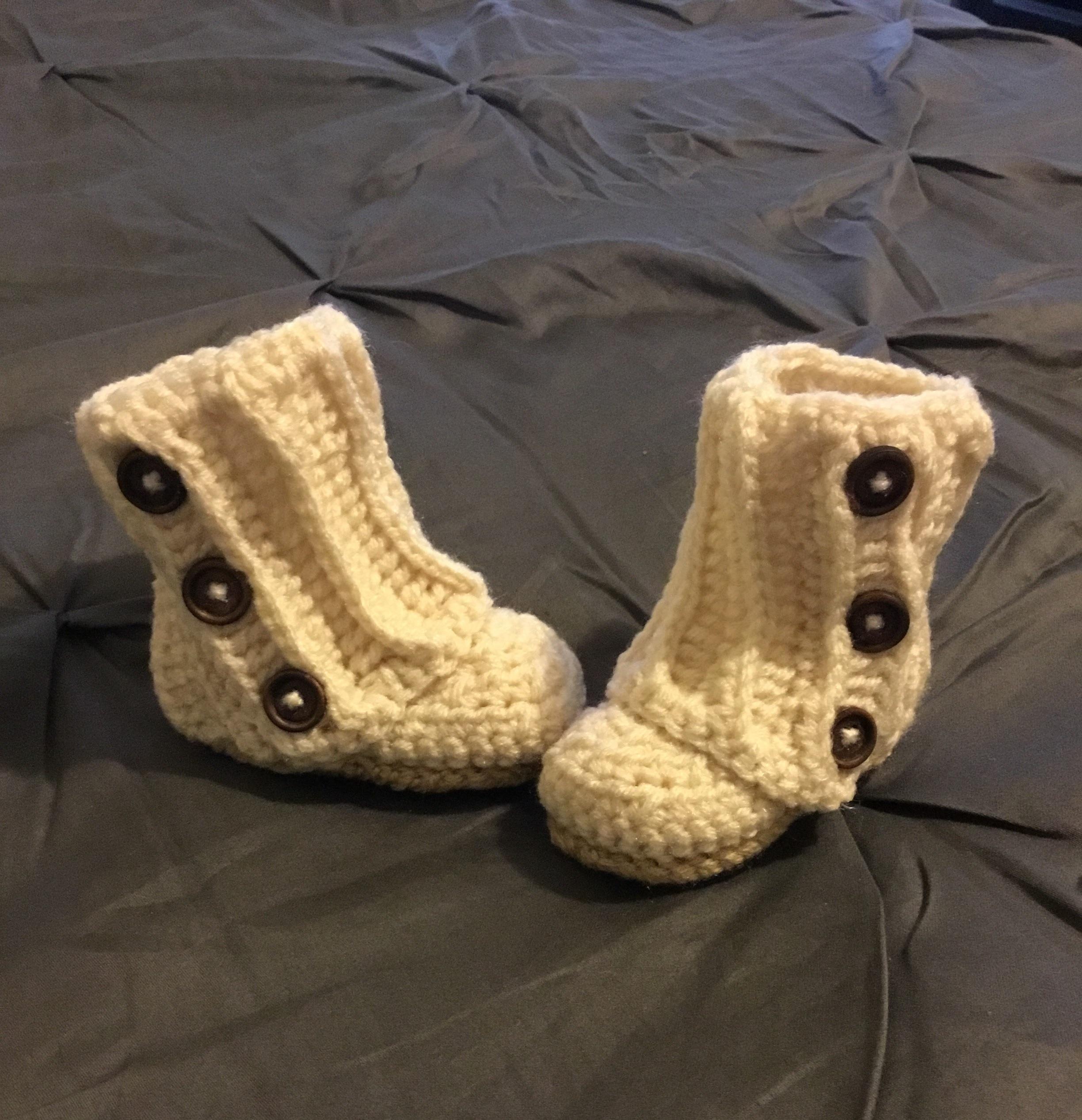 Finally finished these adorable baby boots. Pattern is Baby Wrap Boots