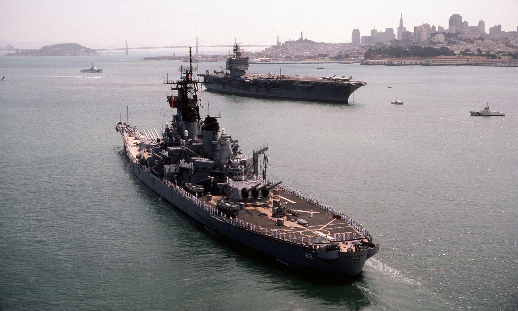 USS New Jersey (BB62) moving past USS ENTERPRISE (CVN 65) in San