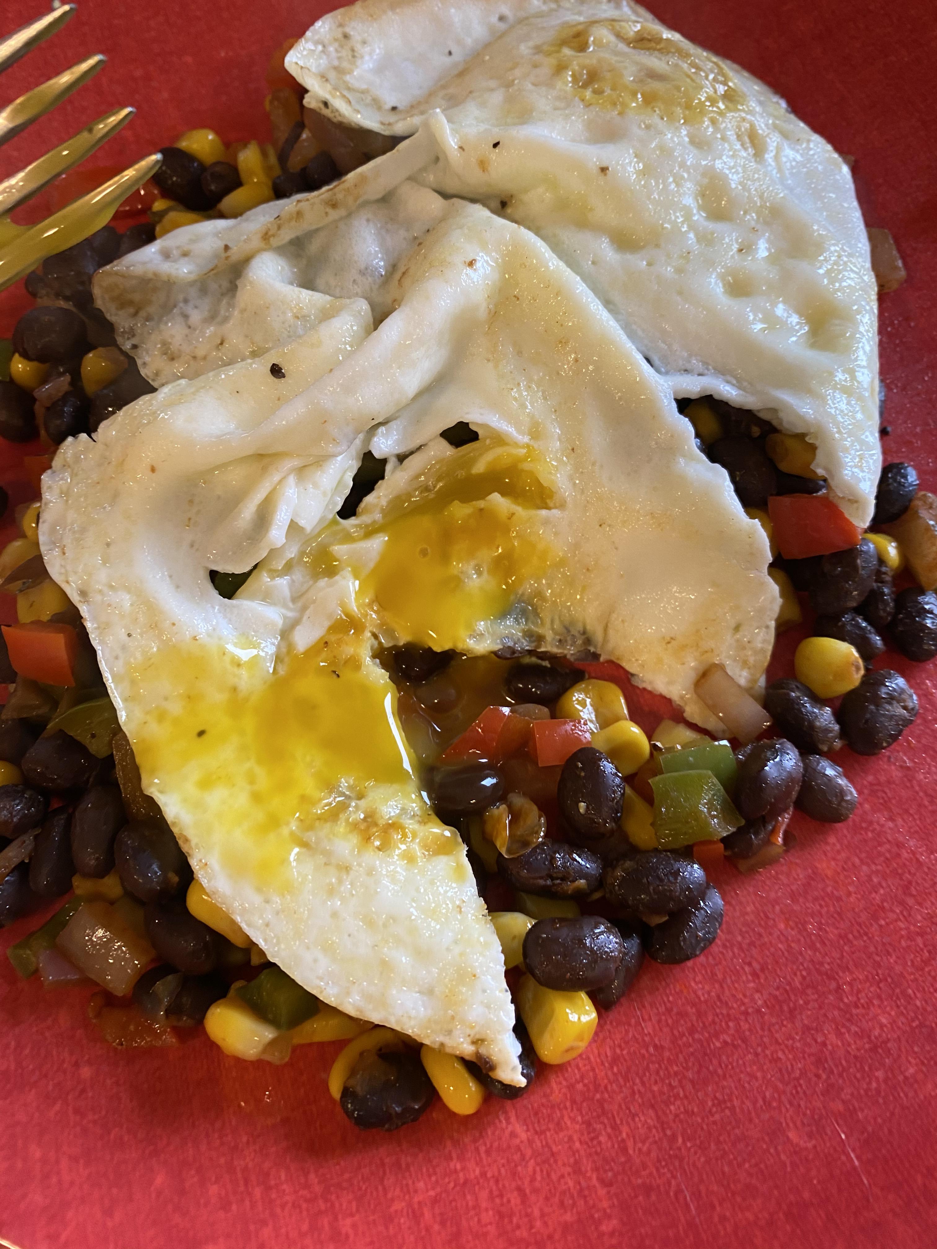 Black beans and bell peppers topped with over easy eggs r/Cheap_Meals