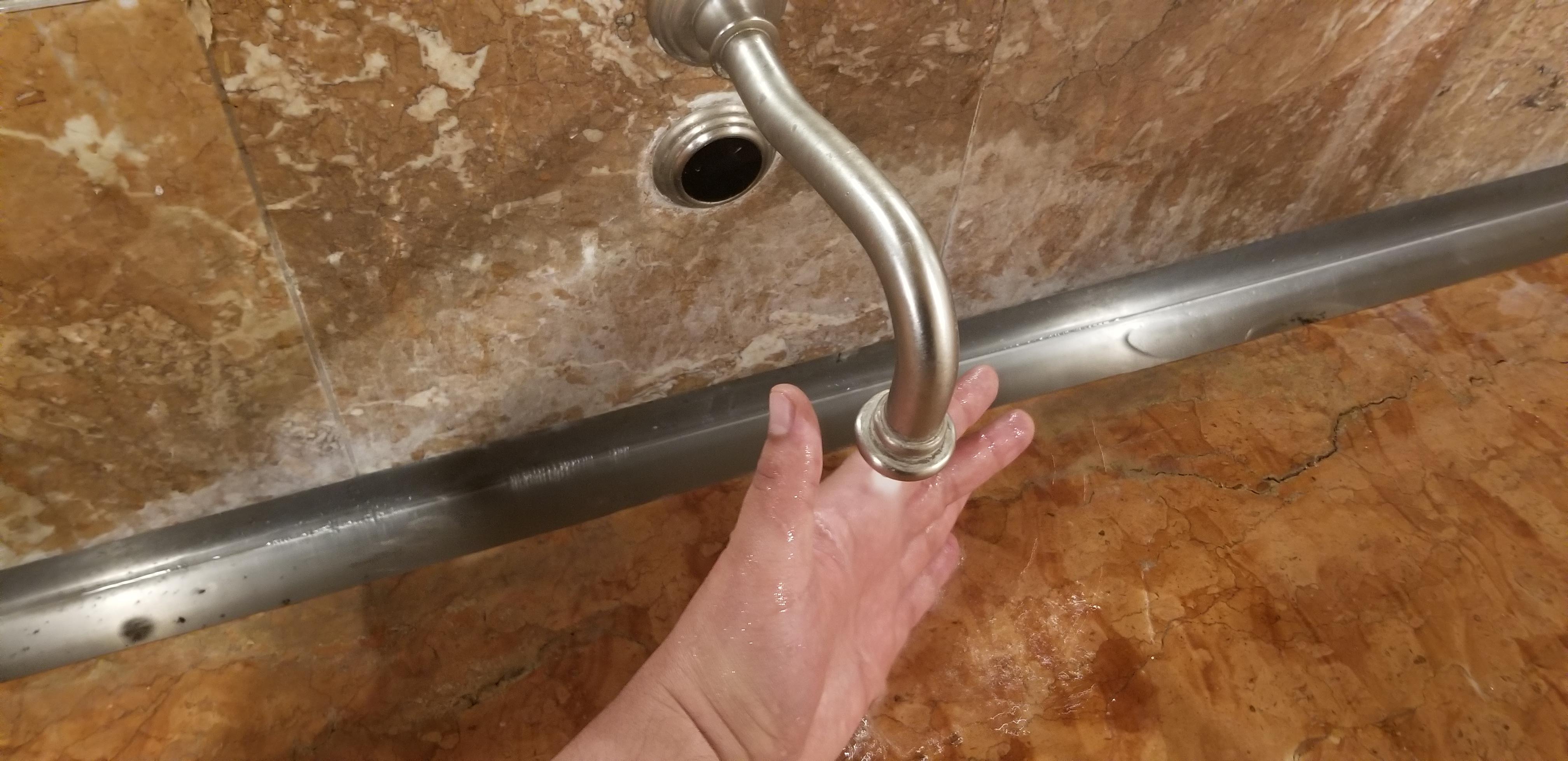 3.5 inches of clearance between the spout and the slab of rock. No