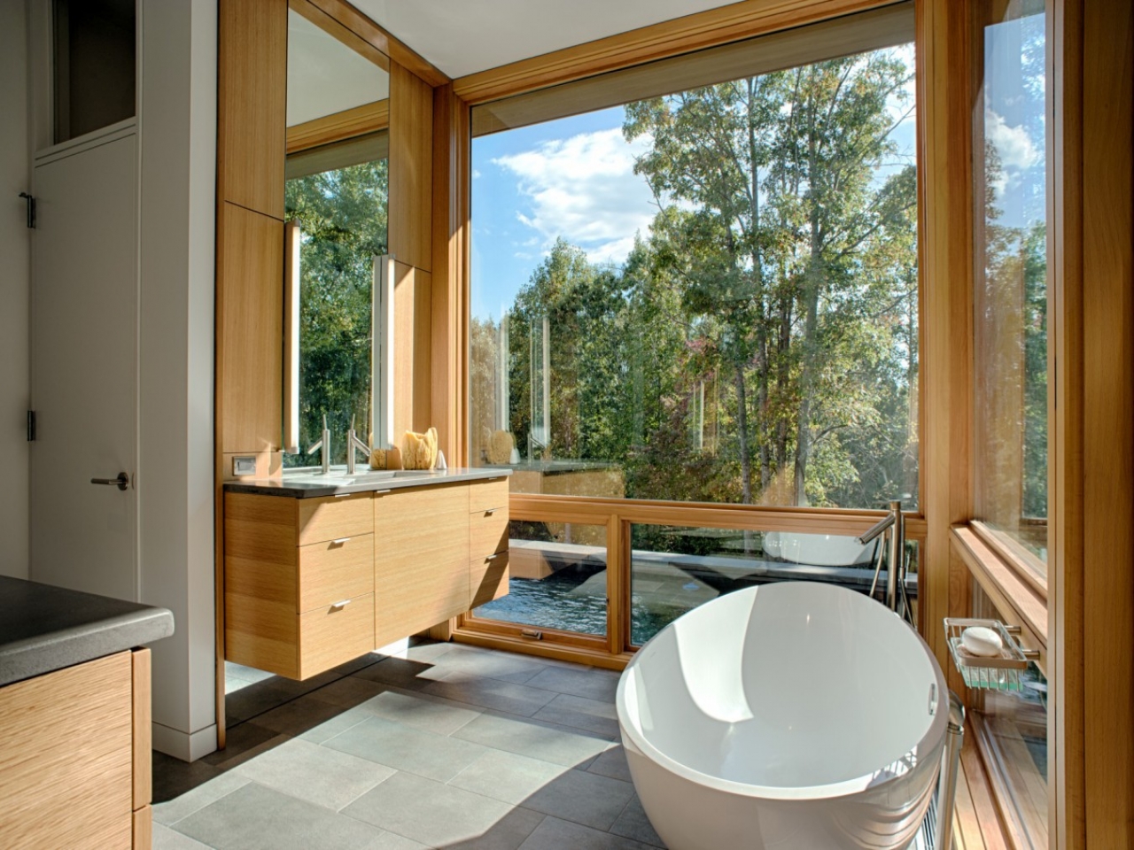 Bathroom with floor to ceiling windows by the pool in a lakeside